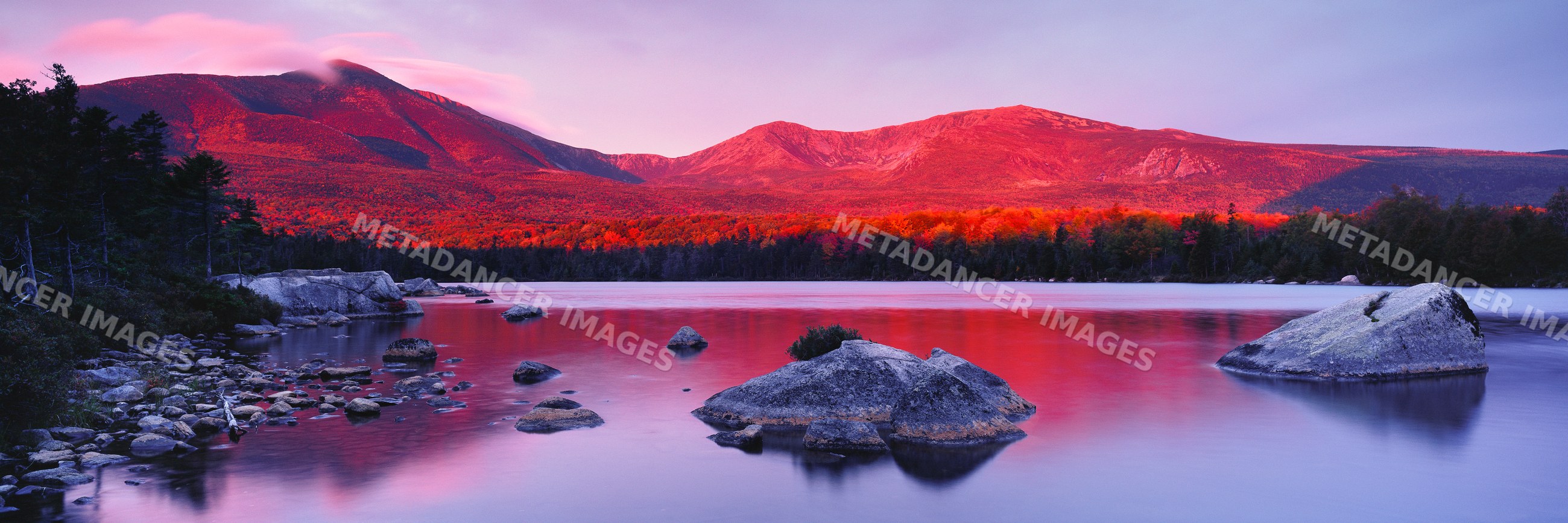 Mount katahdin at sunset reflecting over lake