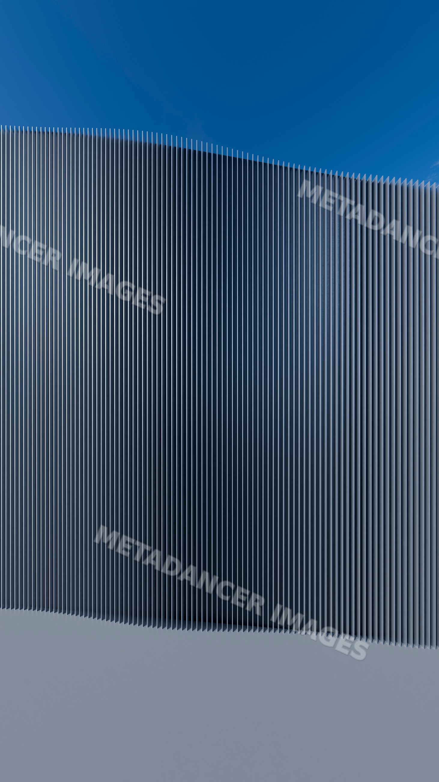 Curved metal fence with vertical bars against blue sky outdoors
