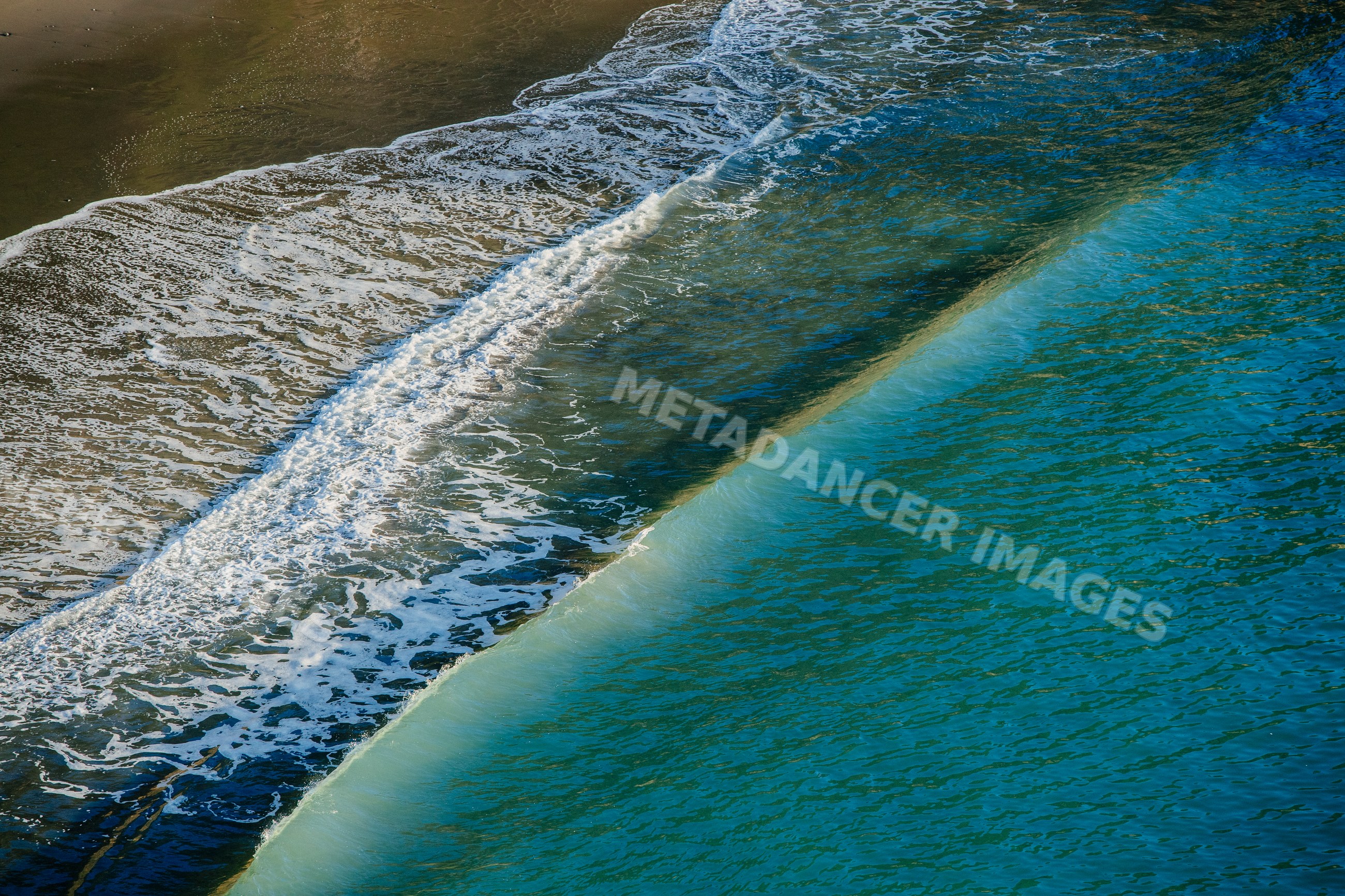 Ocean wave breaking on sandy beach Oregon