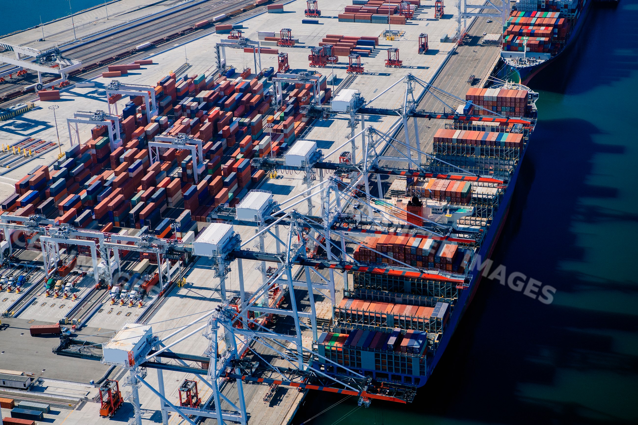 Container ship being loaded at a busy port shipping terminal