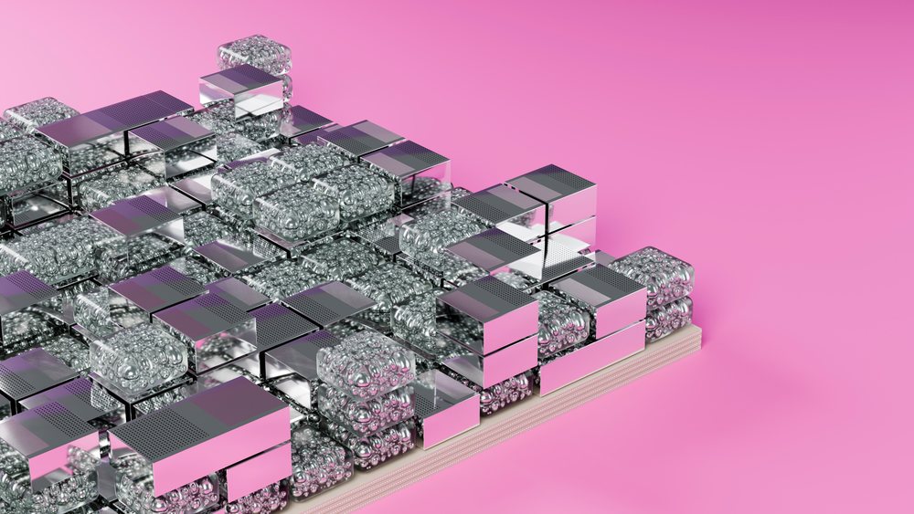 Stacked reflective metal and glass cubes on pink background