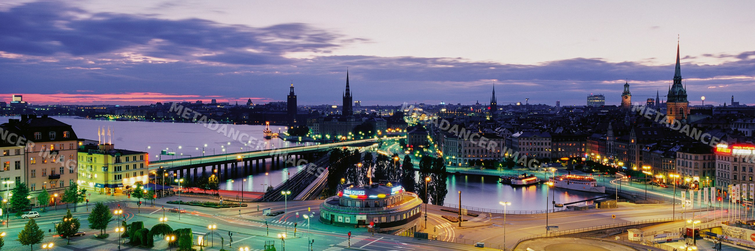 Stockholm city skyline at dusk with illuminated bridges and historic