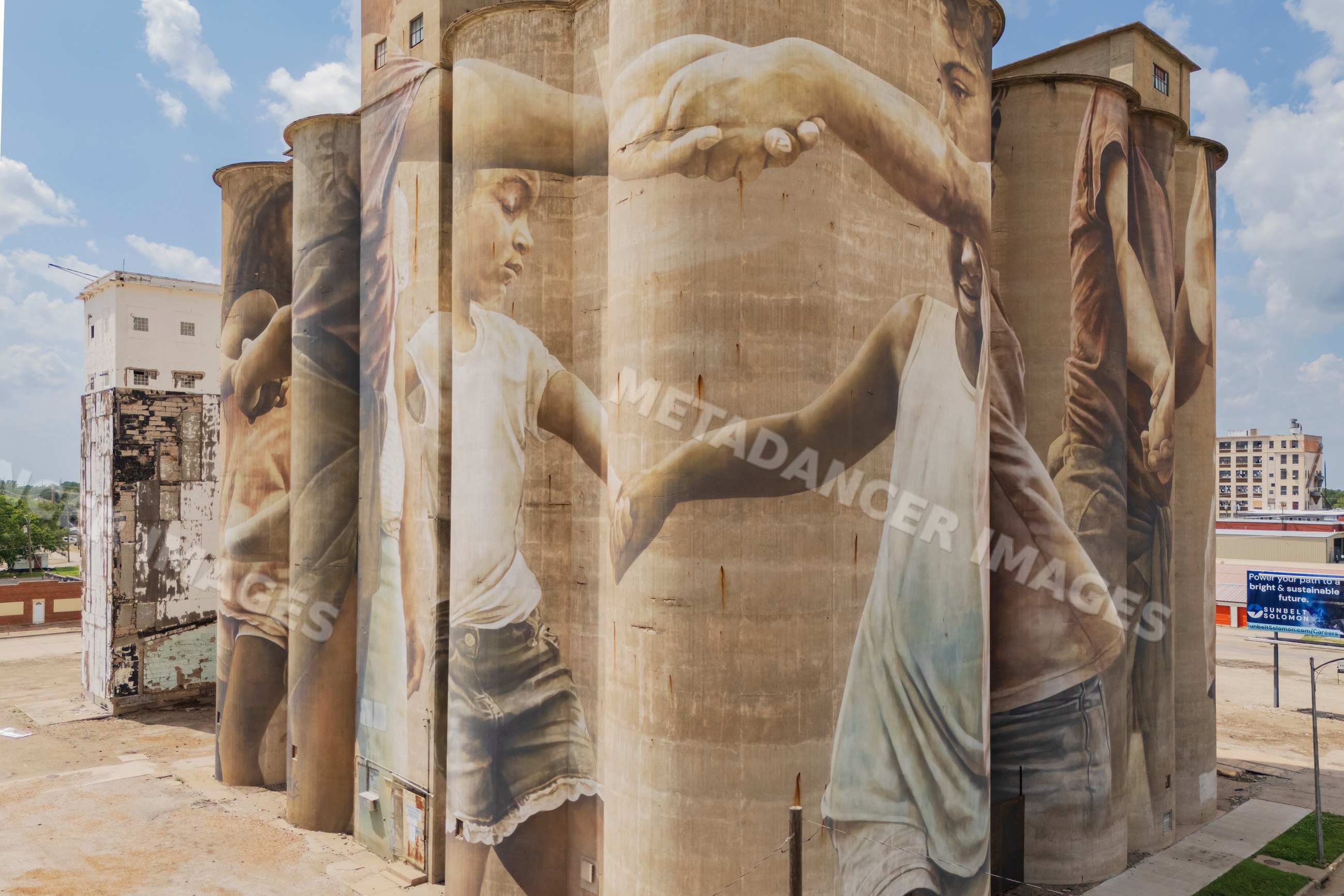 Grain Silo mural of children holding hands in salina kansas