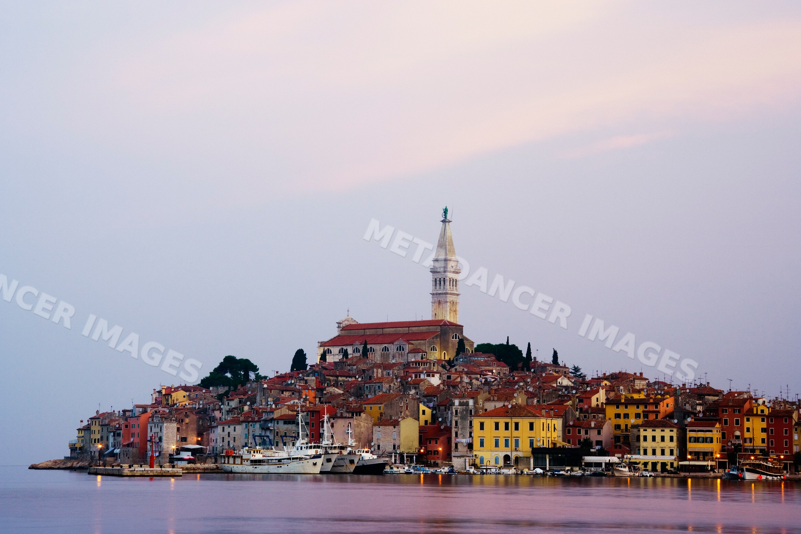 Town of rovinj with church tower and boats in harbor croatia