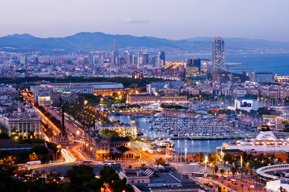 Evening cityscape of barcelona overlooking marina and urban skyline