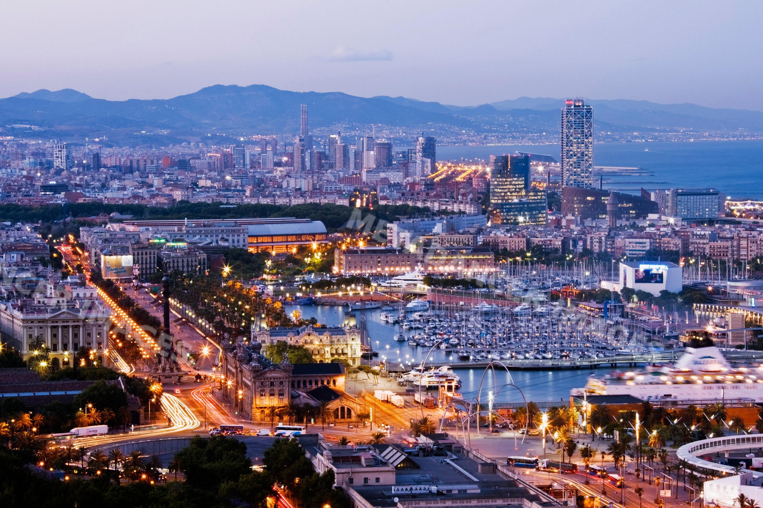 Evening cityscape of barcelona overlooking marina and urban skyline