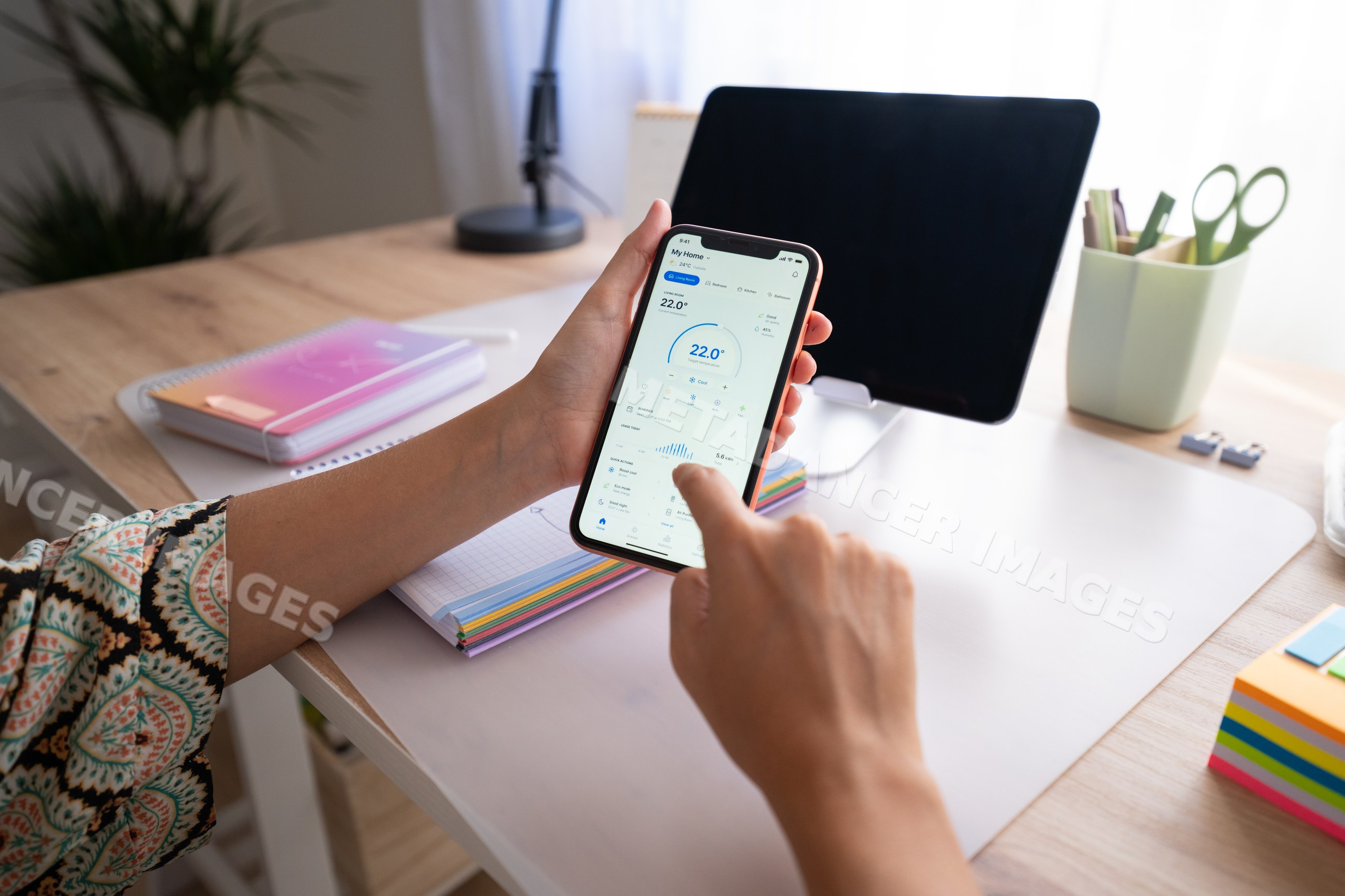 White person smartphone checking app screen at desk in home office
