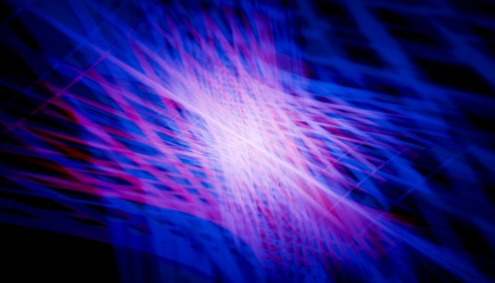 Abstract dynamic streaks of blue and purple light create a vibrant