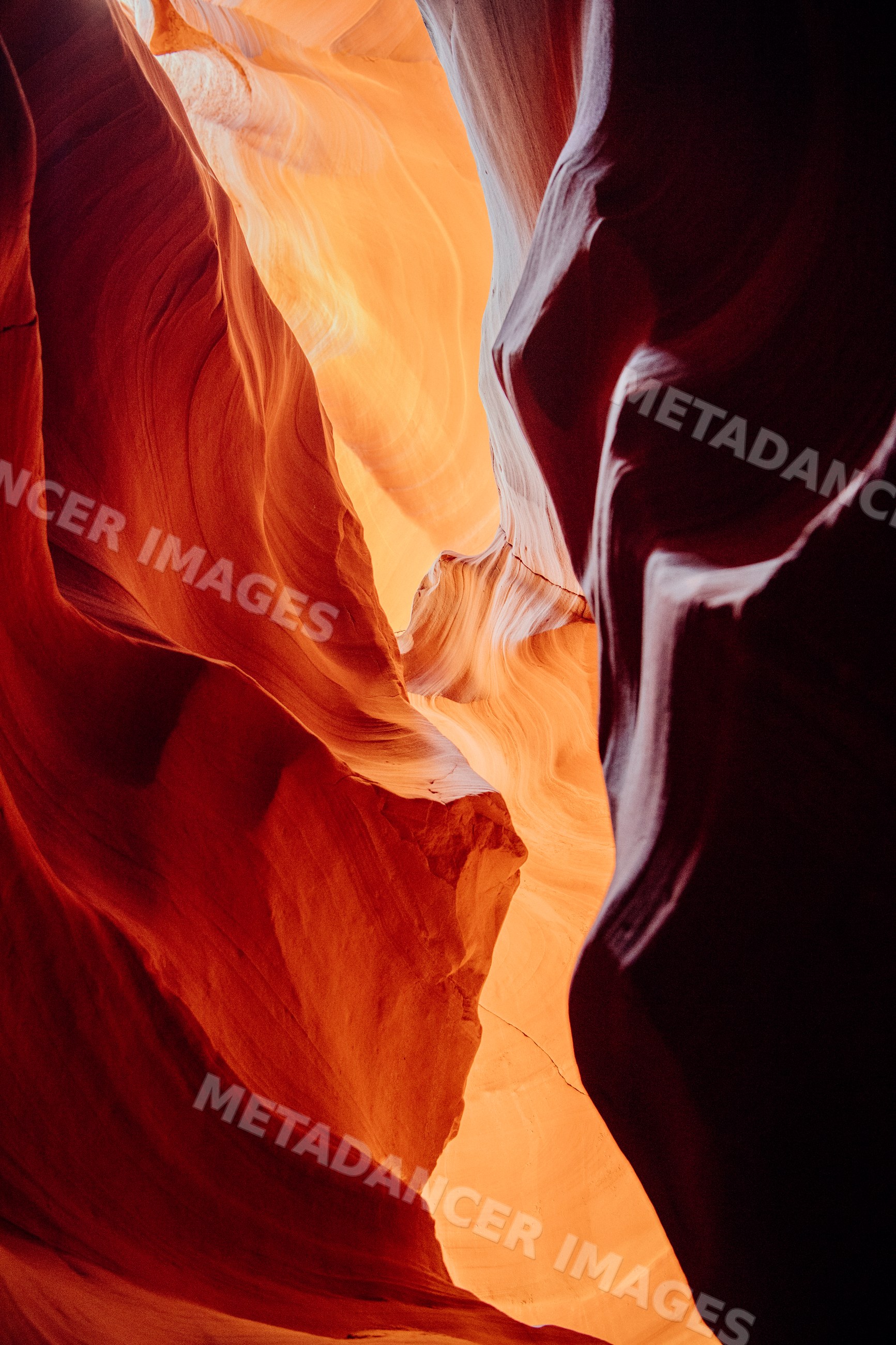 Sunlit curving sandstone walls of antelope canyon