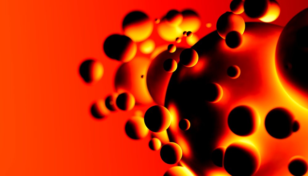 Close-up view of glowing floating spheres on a bright orange