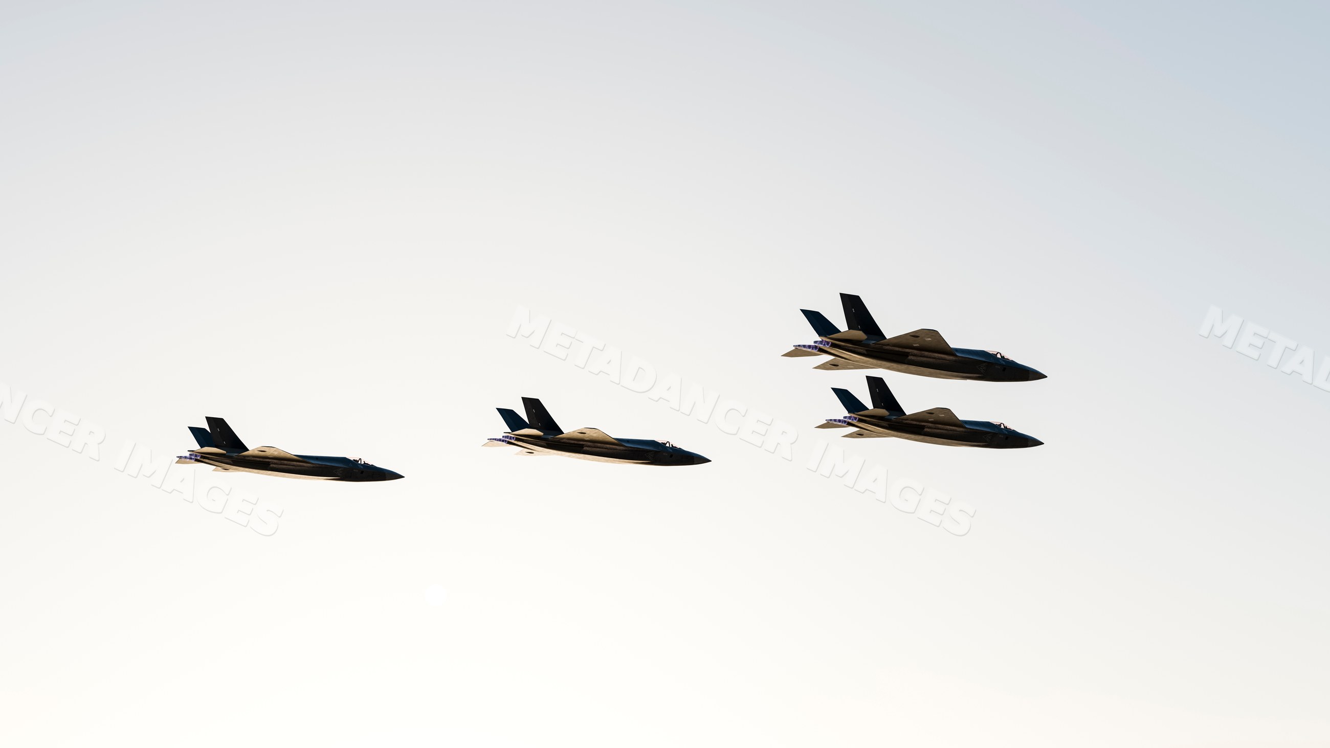 Four fighter jets flying in formation