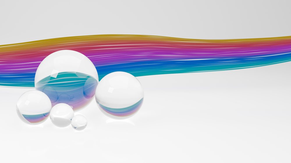 Transparent glass spheres with colorful streaks on a white background