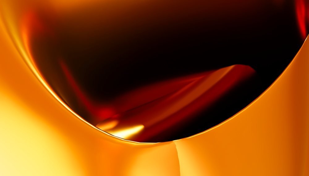 Close-up of golden orange liquid with glossy smooth surface
