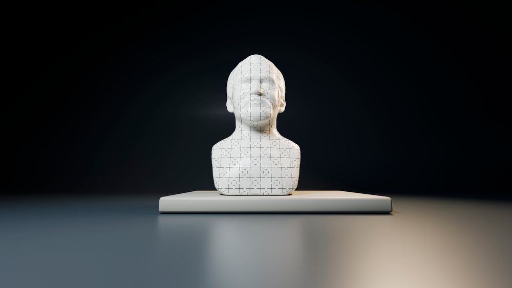 White three-dimensional human head puzzle bust on smooth surface