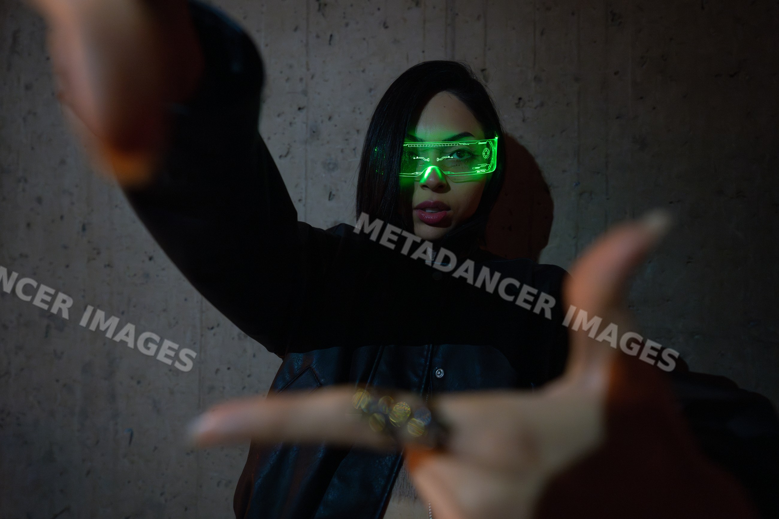 Hispanic woman wearing futuristic green glowing glasses against dark