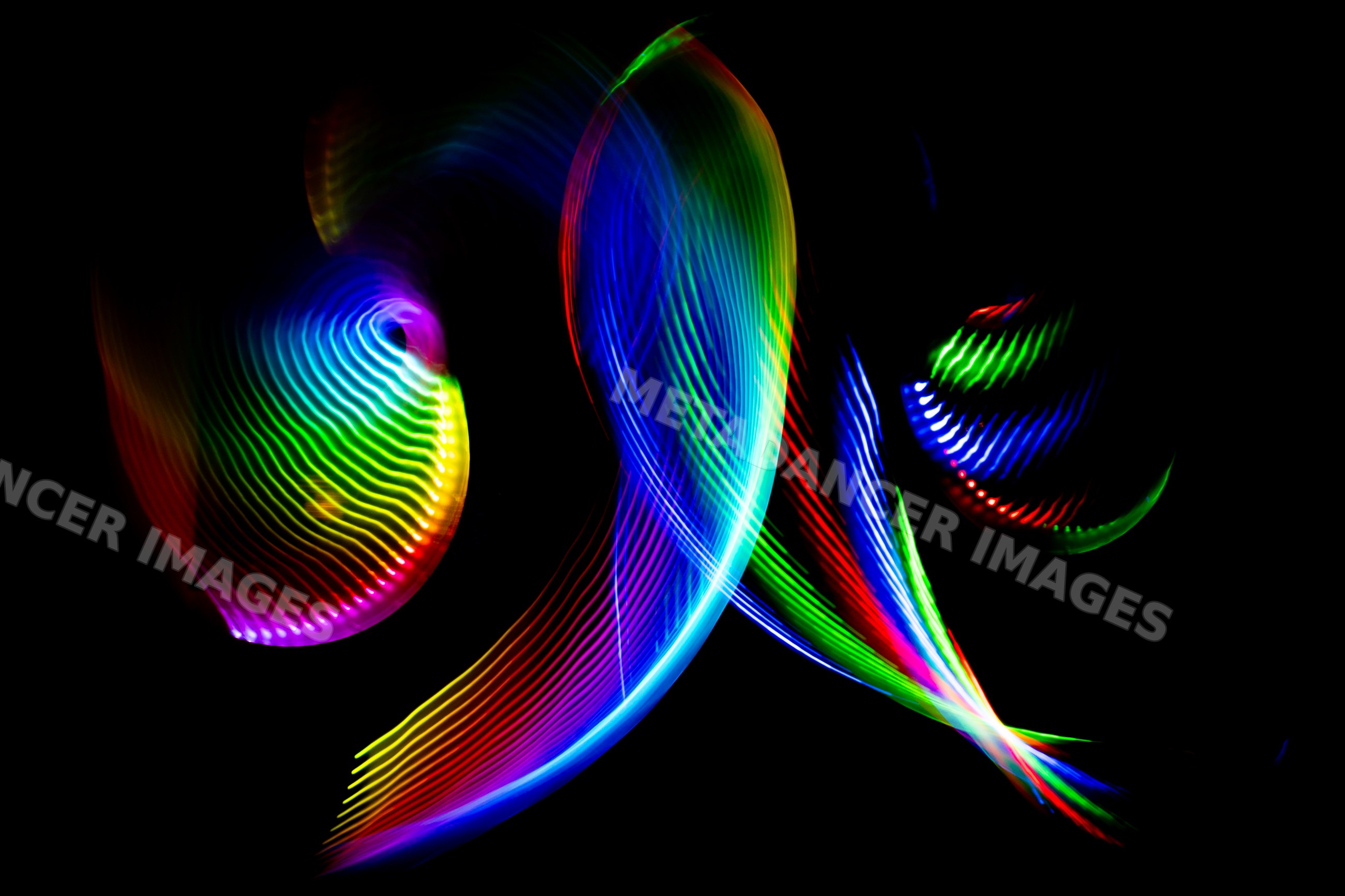 Colorful swirling light painting with led trails on black background