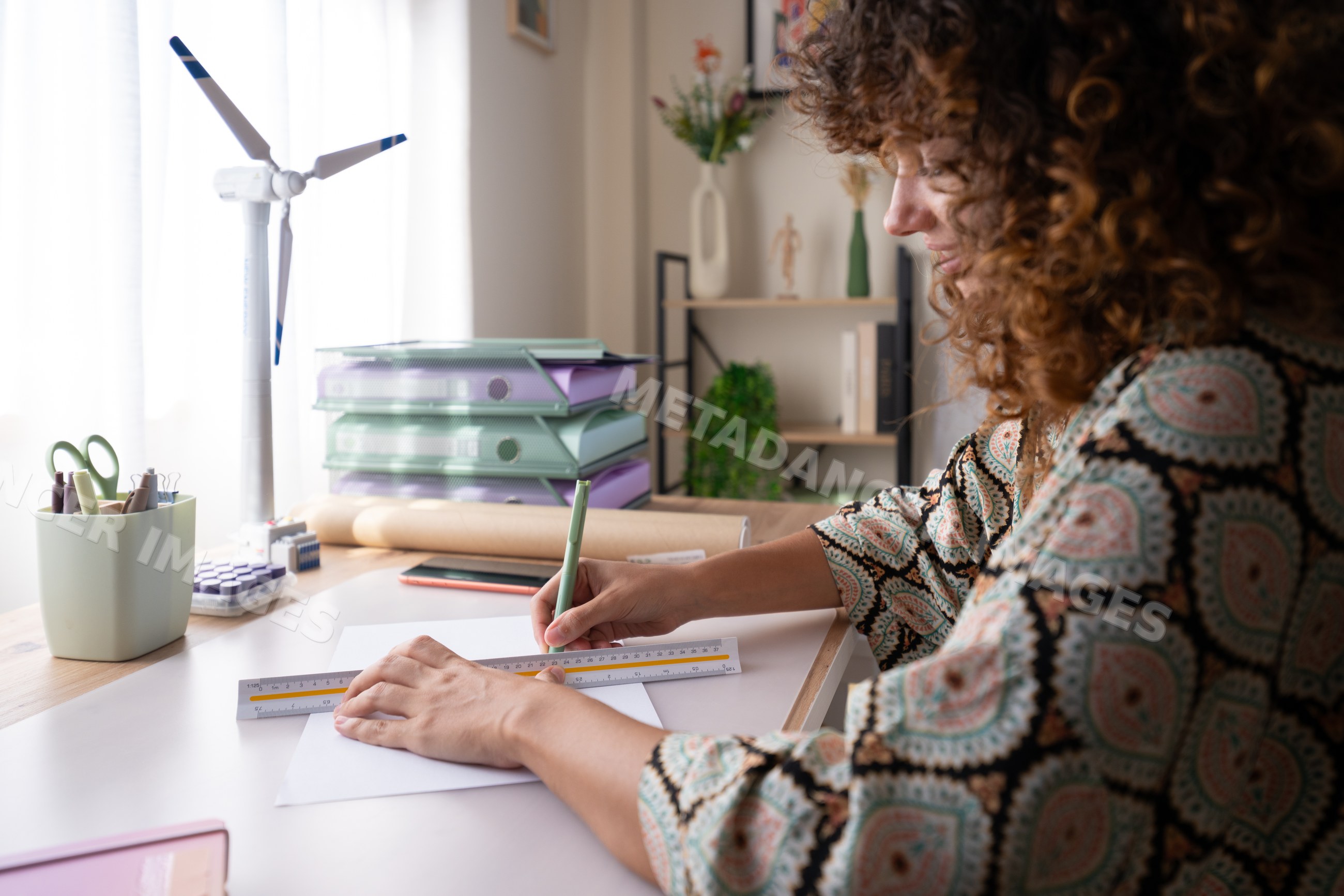 White woman measuring and drawing on paper