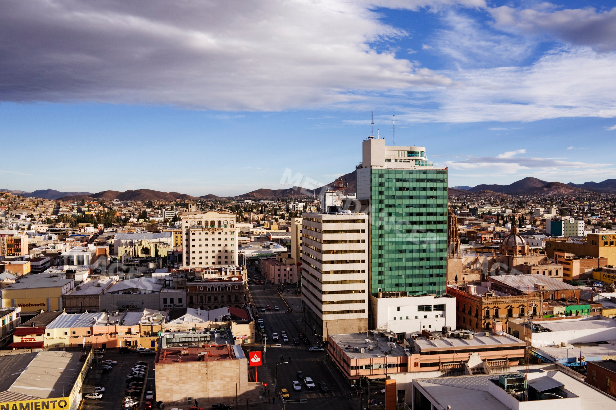 Cityscape of chihuahua with urban buildings and mountain backdrop