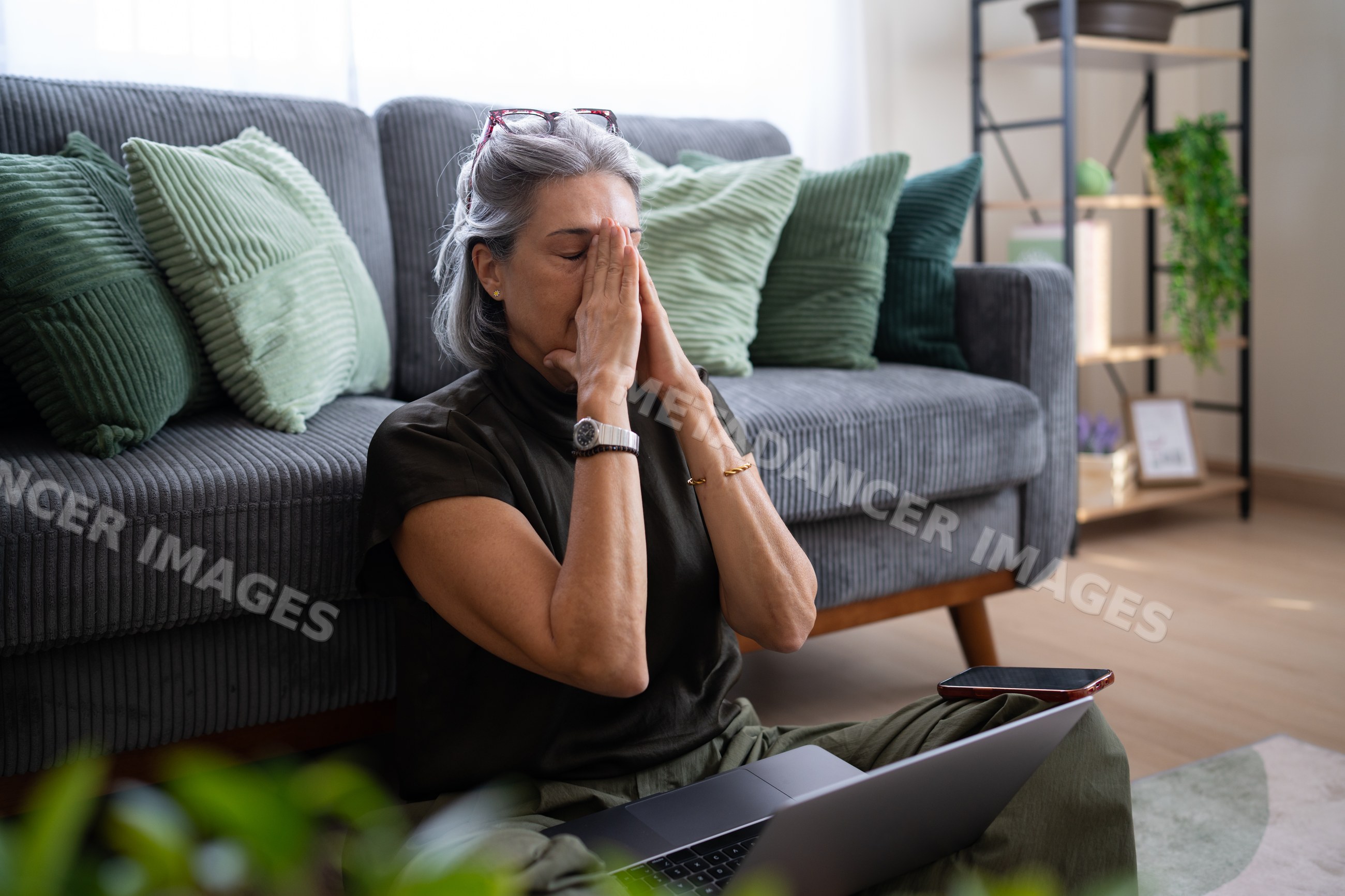 White woman sitting on floor with laptop relaxing at home in Spain