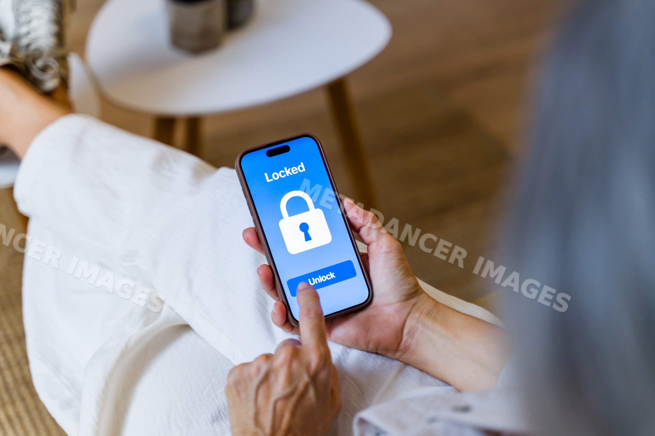 White woman using smartphone to unlock locked screen indoors