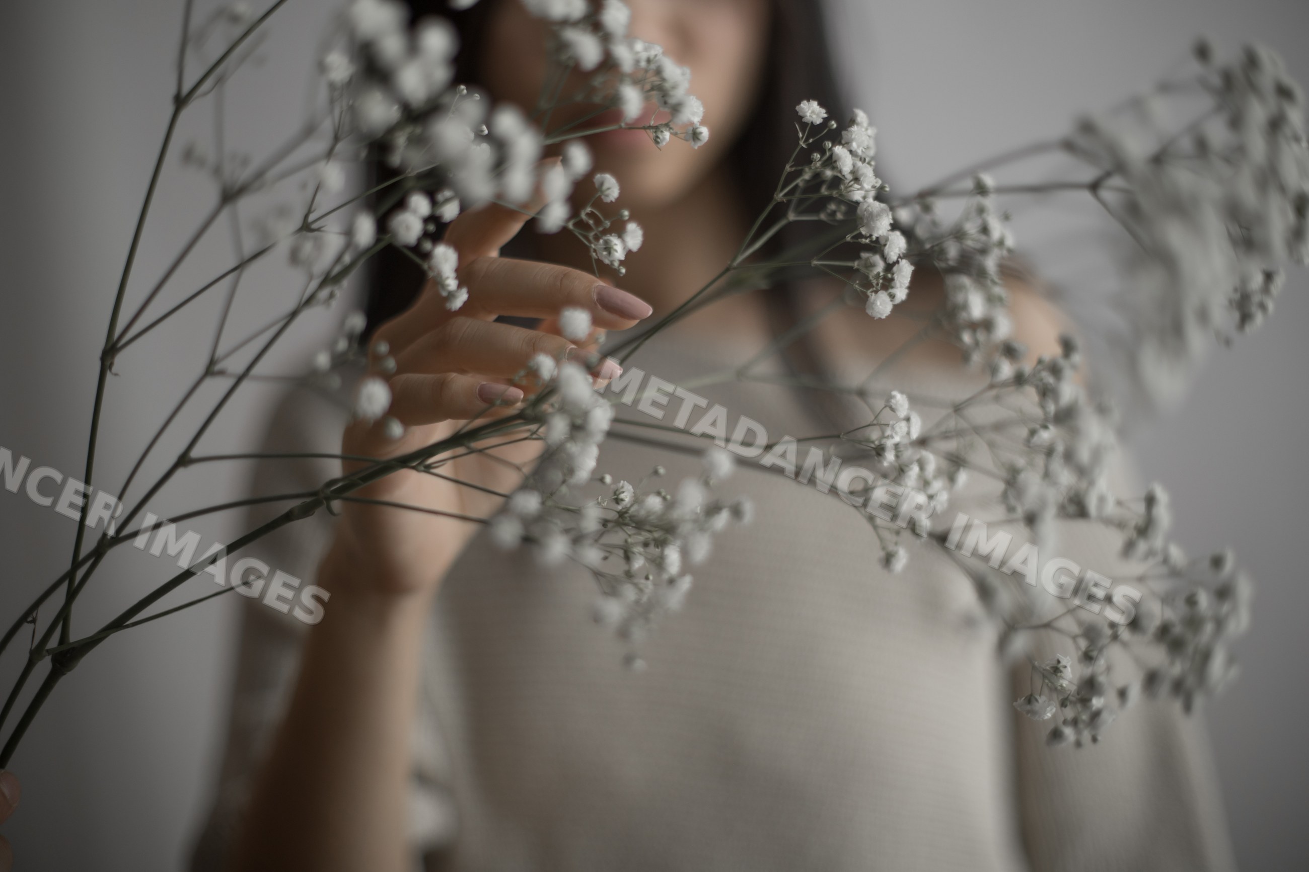 Southeast Asian woman holding delicate baby's breath flowers