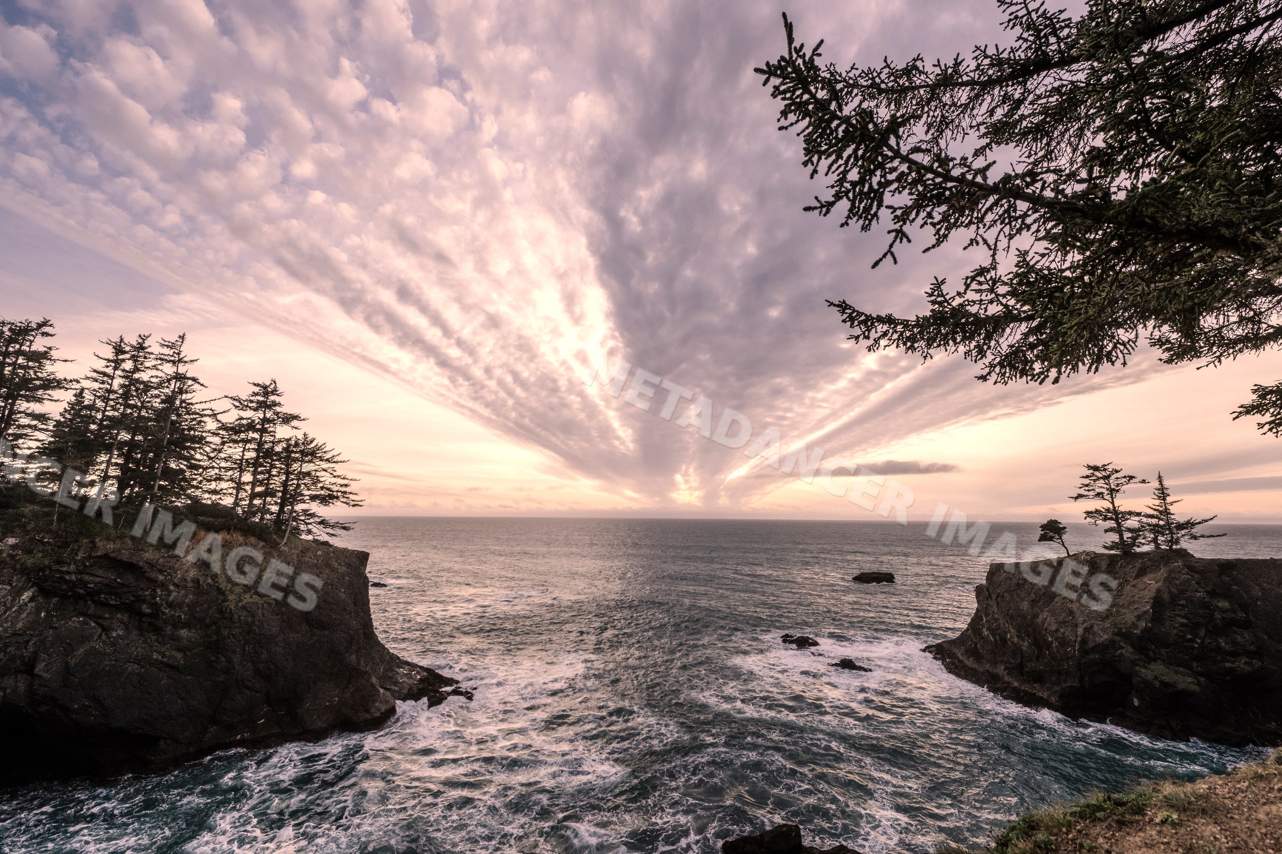 Ocean waves and rocky cliffs at sunset