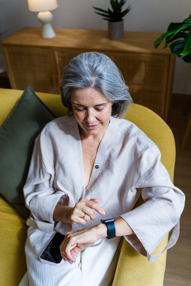 Senior white woman using a smartwatch