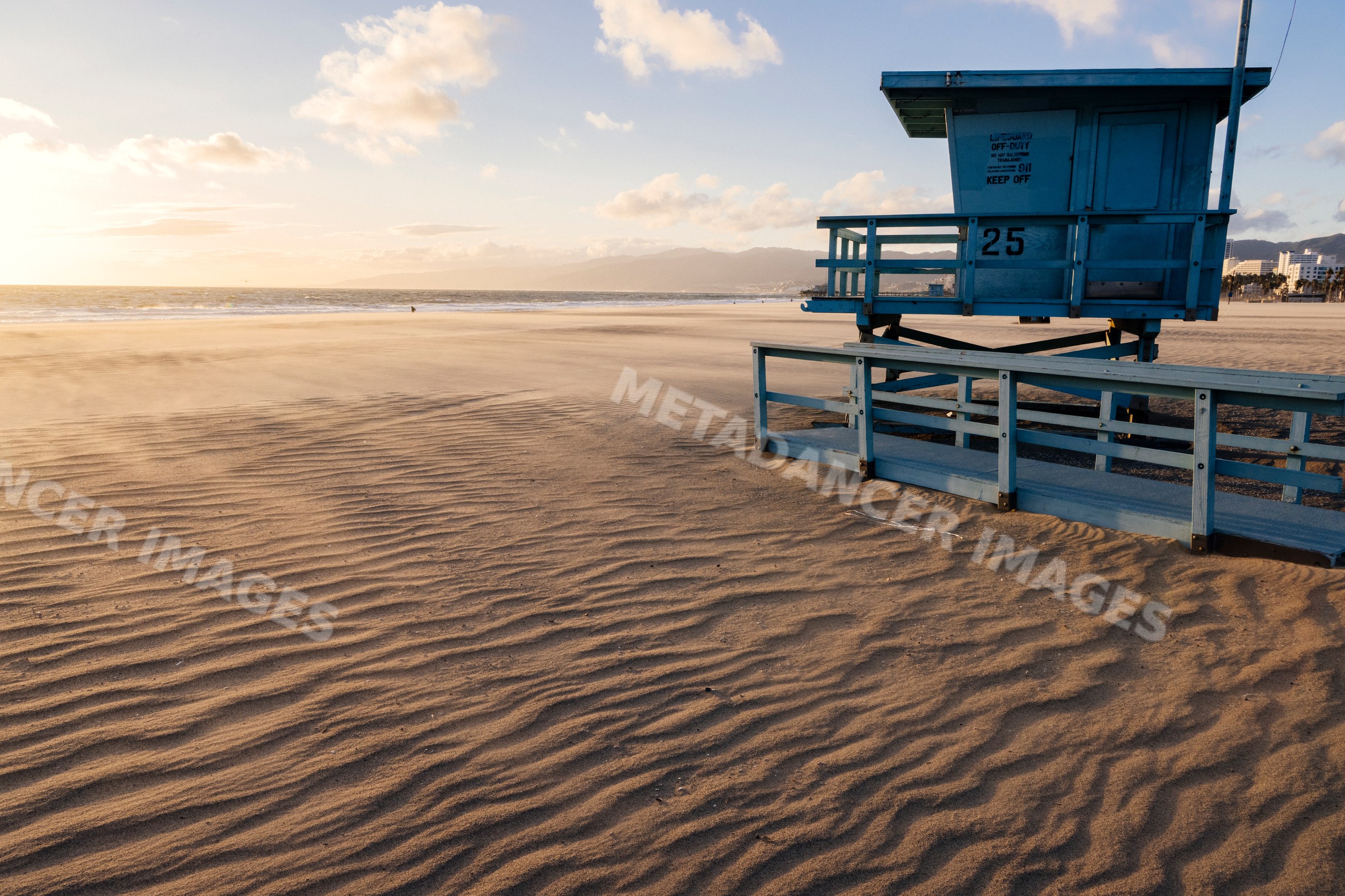 Lifeguard tower on Venice Beach shore at sunset