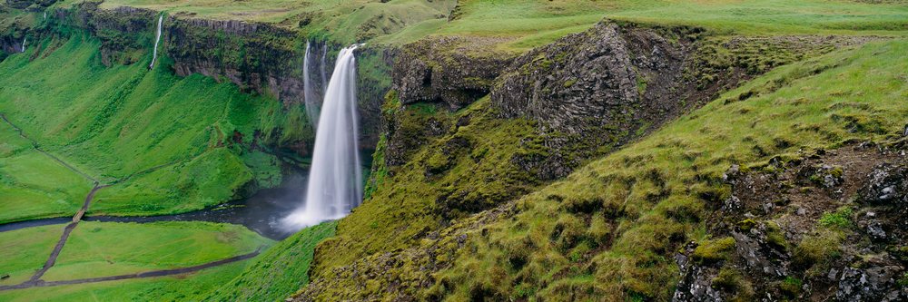 Seljalandsfoss waterfall cascading down cliffs landscape