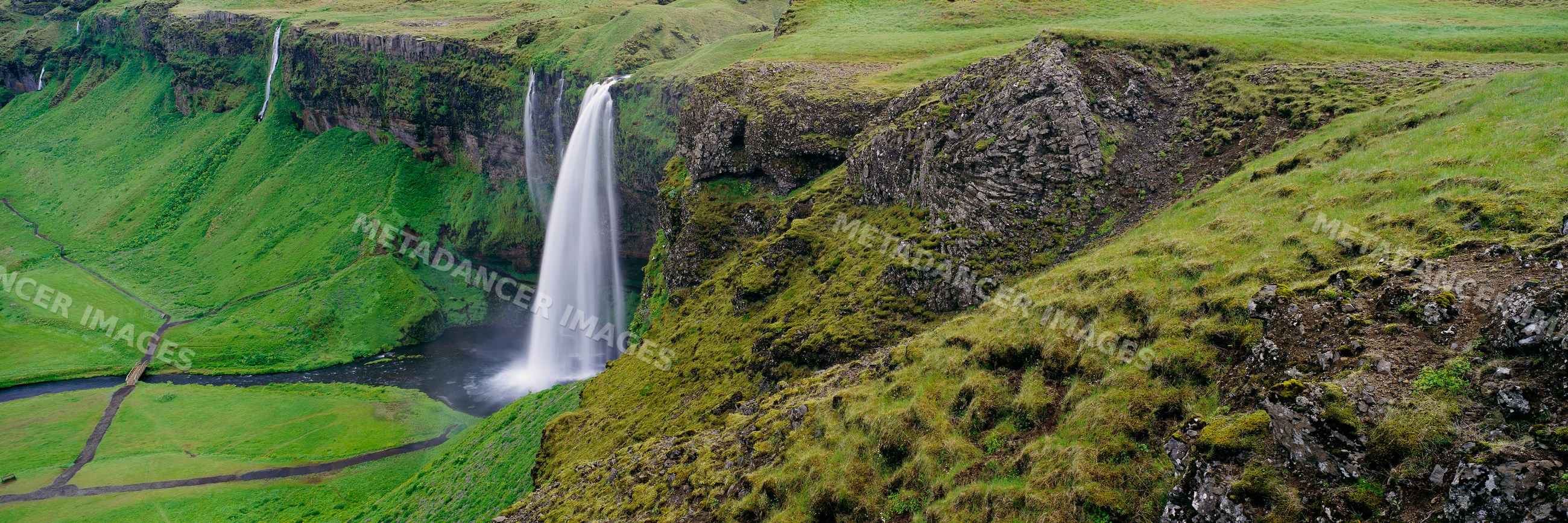 Seljalandsfoss waterfall cascading down cliffs landscape