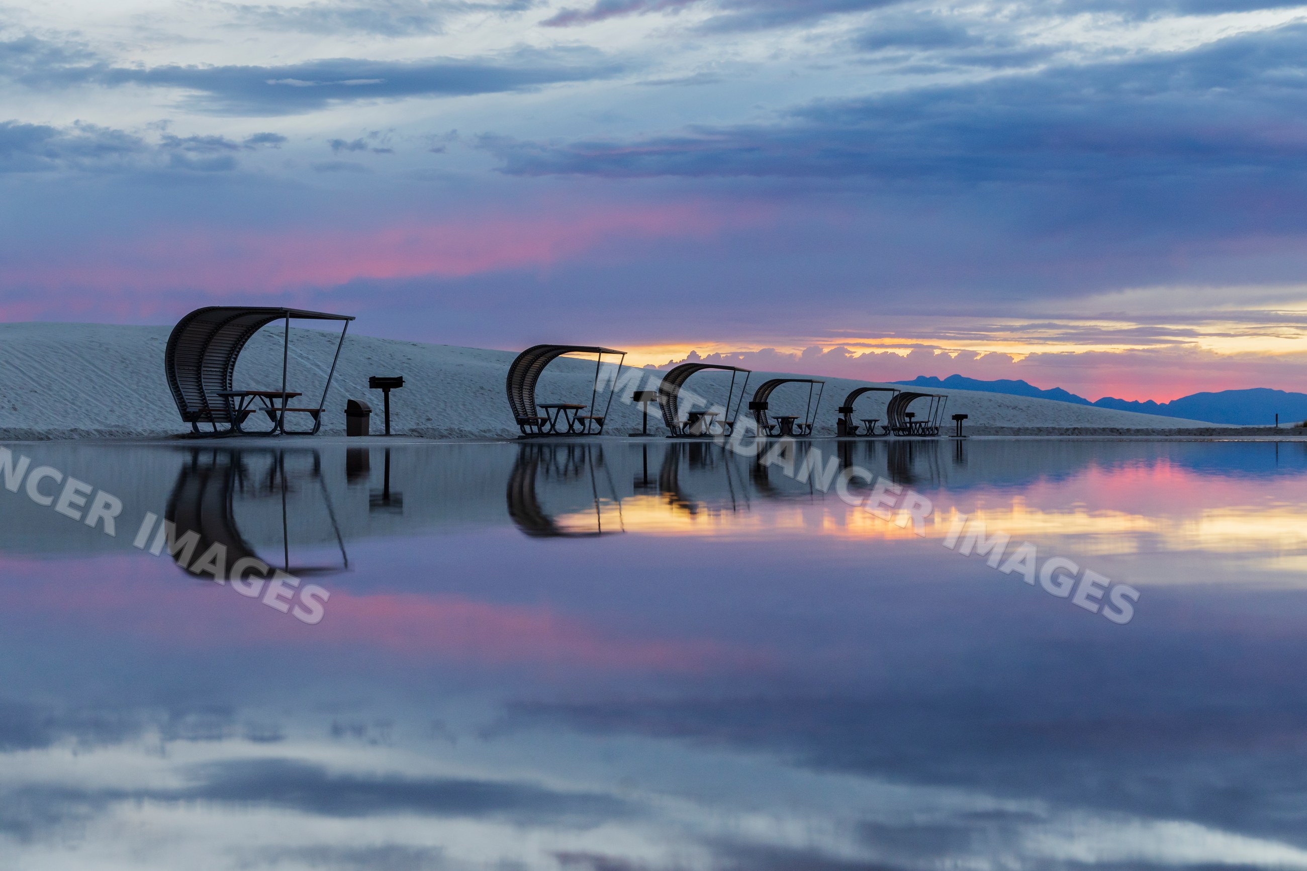 Picnic shelters reflected at sunset