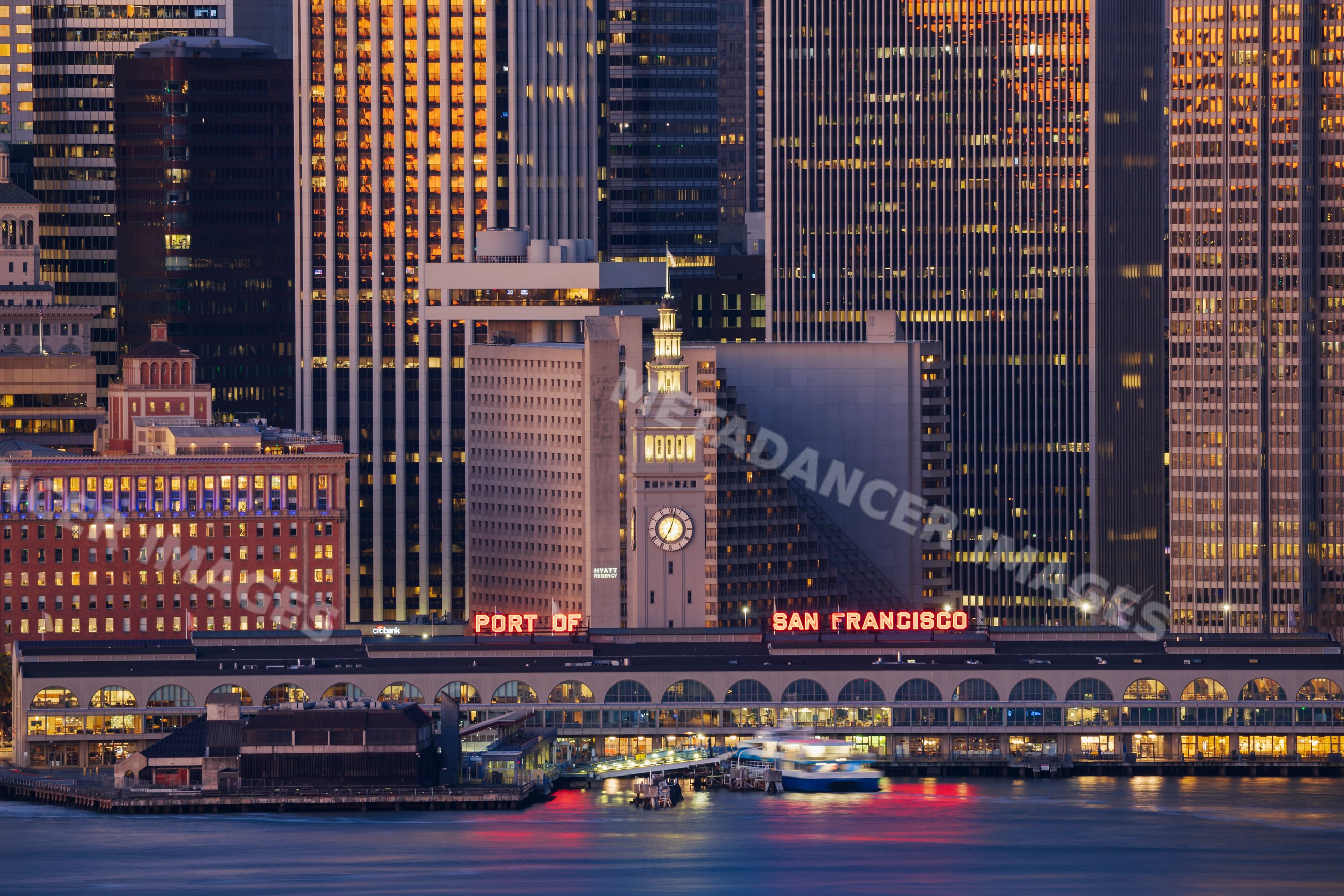 Port of San Francisco ferry building with city skyline at dusk