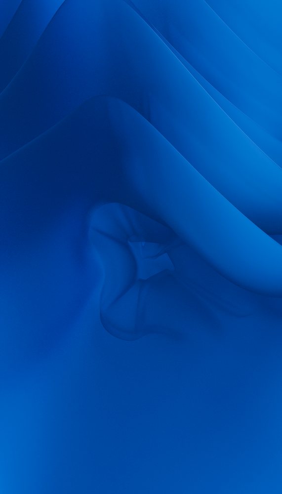 Close-up shot of blue fabric with abstract folds and wrinkles