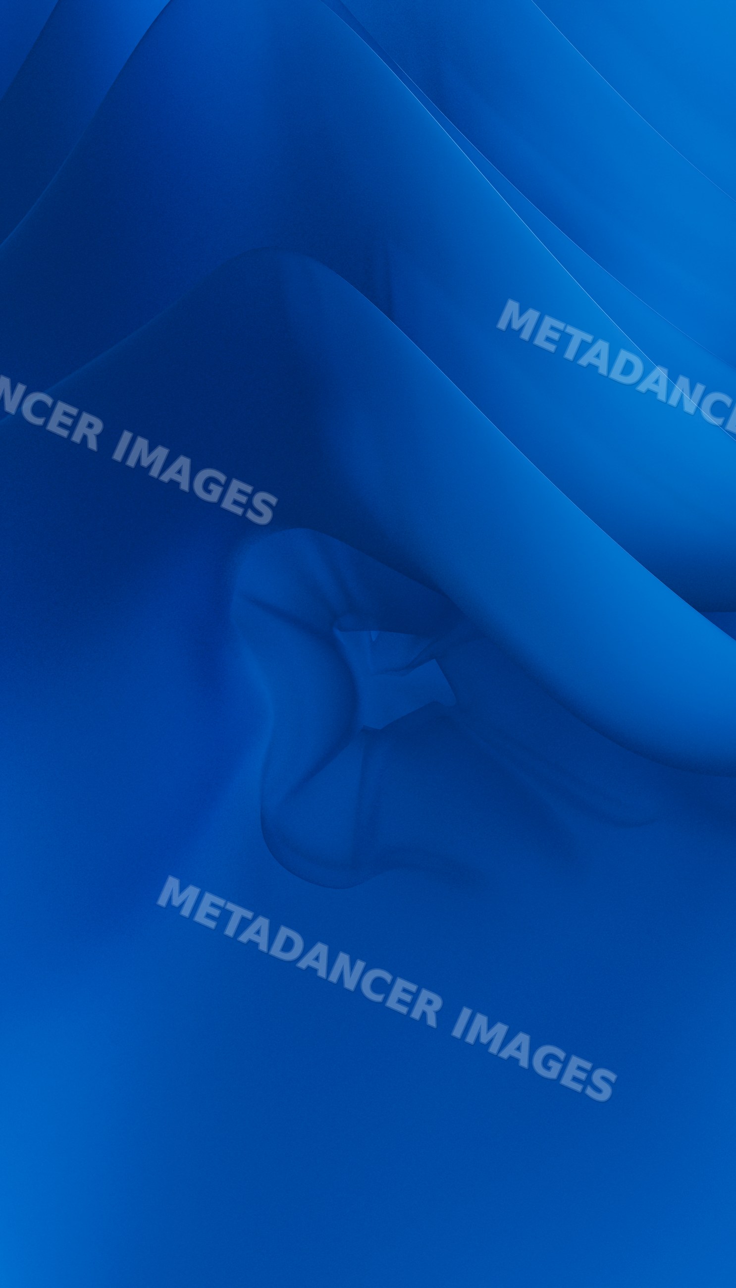 Close-up shot of blue fabric with abstract folds and wrinkles