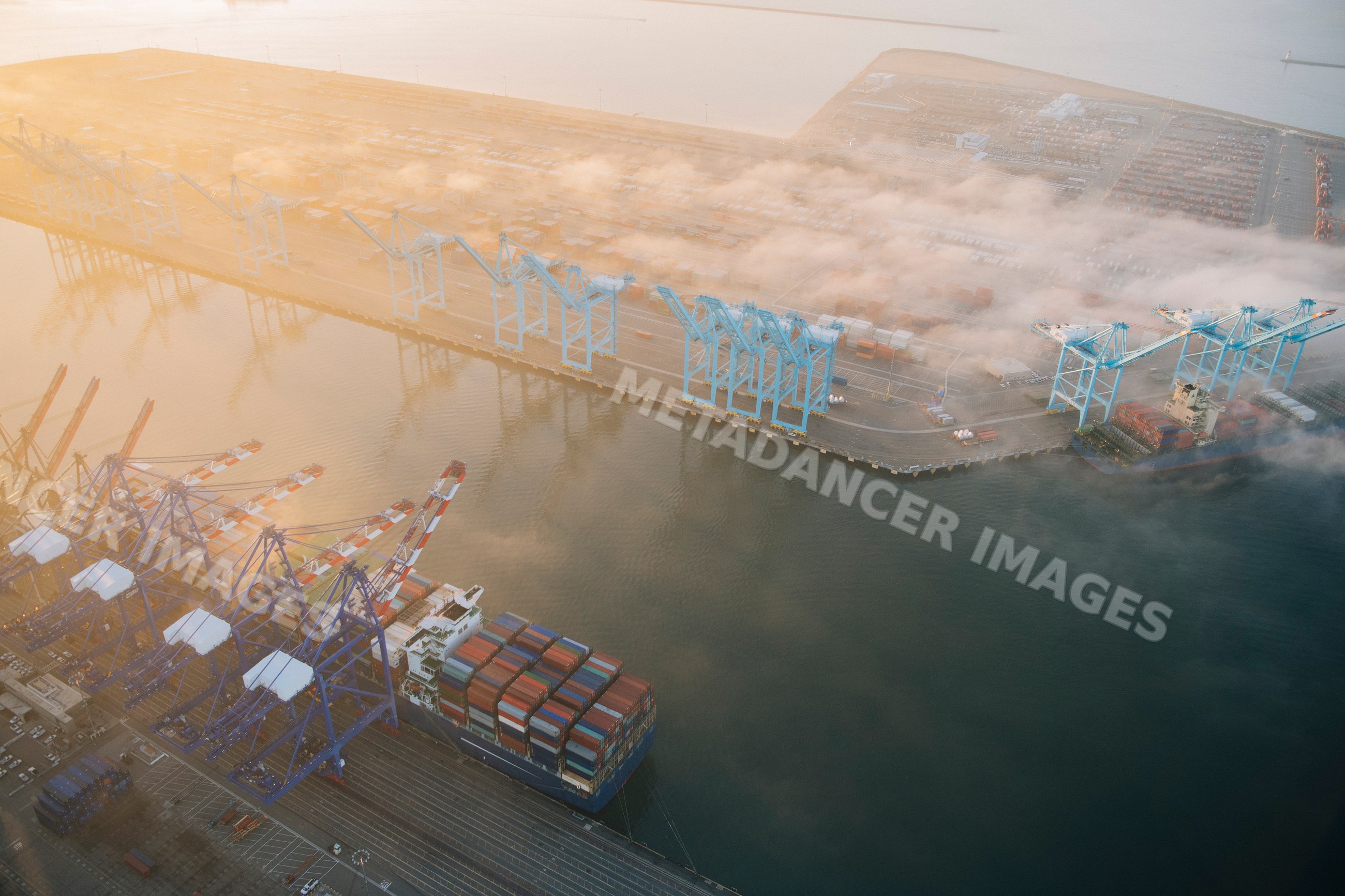 An aerial view of cargo port operations with container cranes in Long