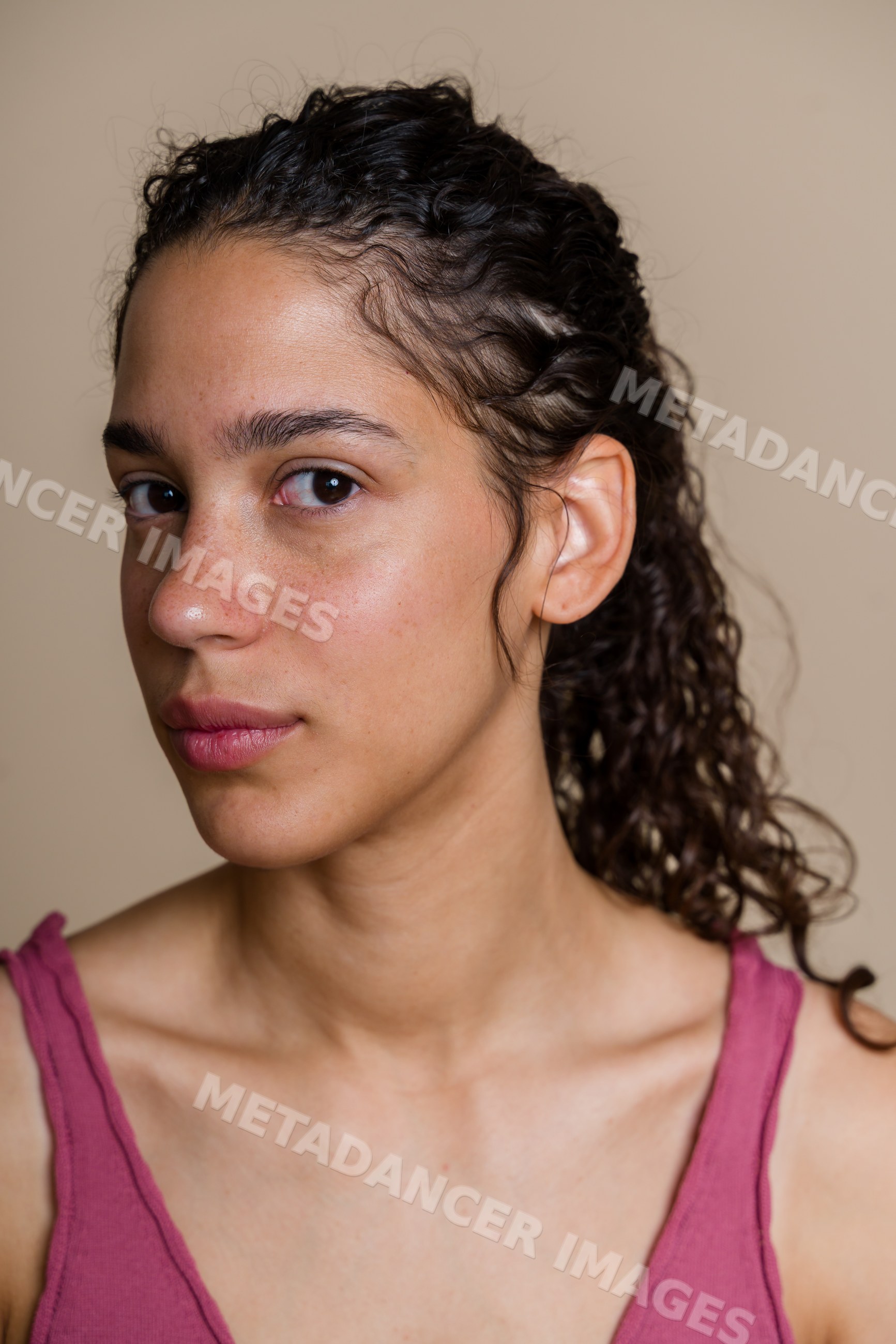 Hispanic woman portrait with curly hair and natural skin