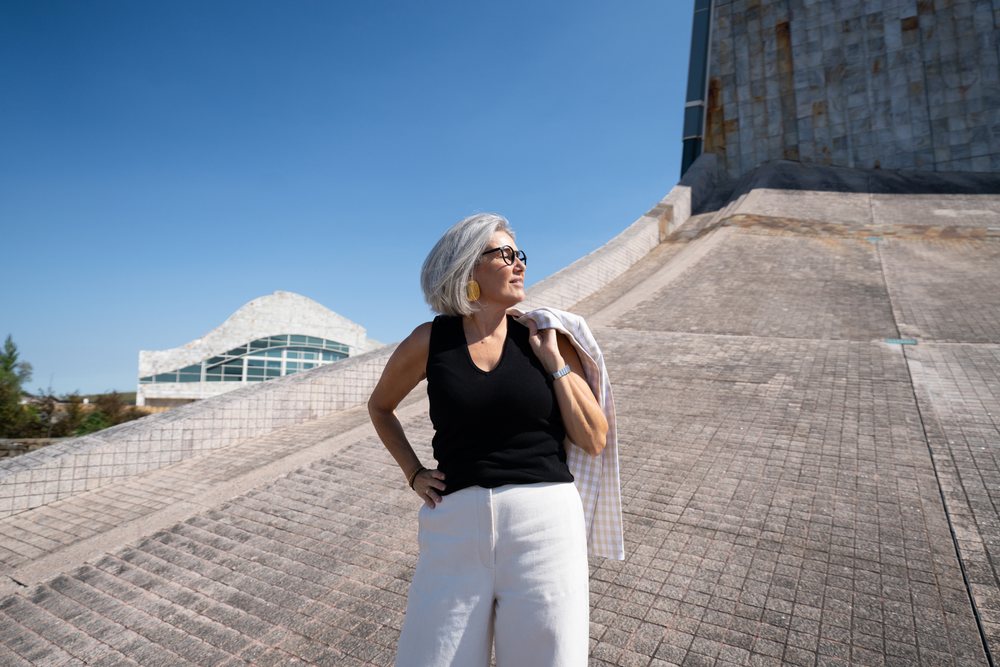 White woman standing in front of modern architecture