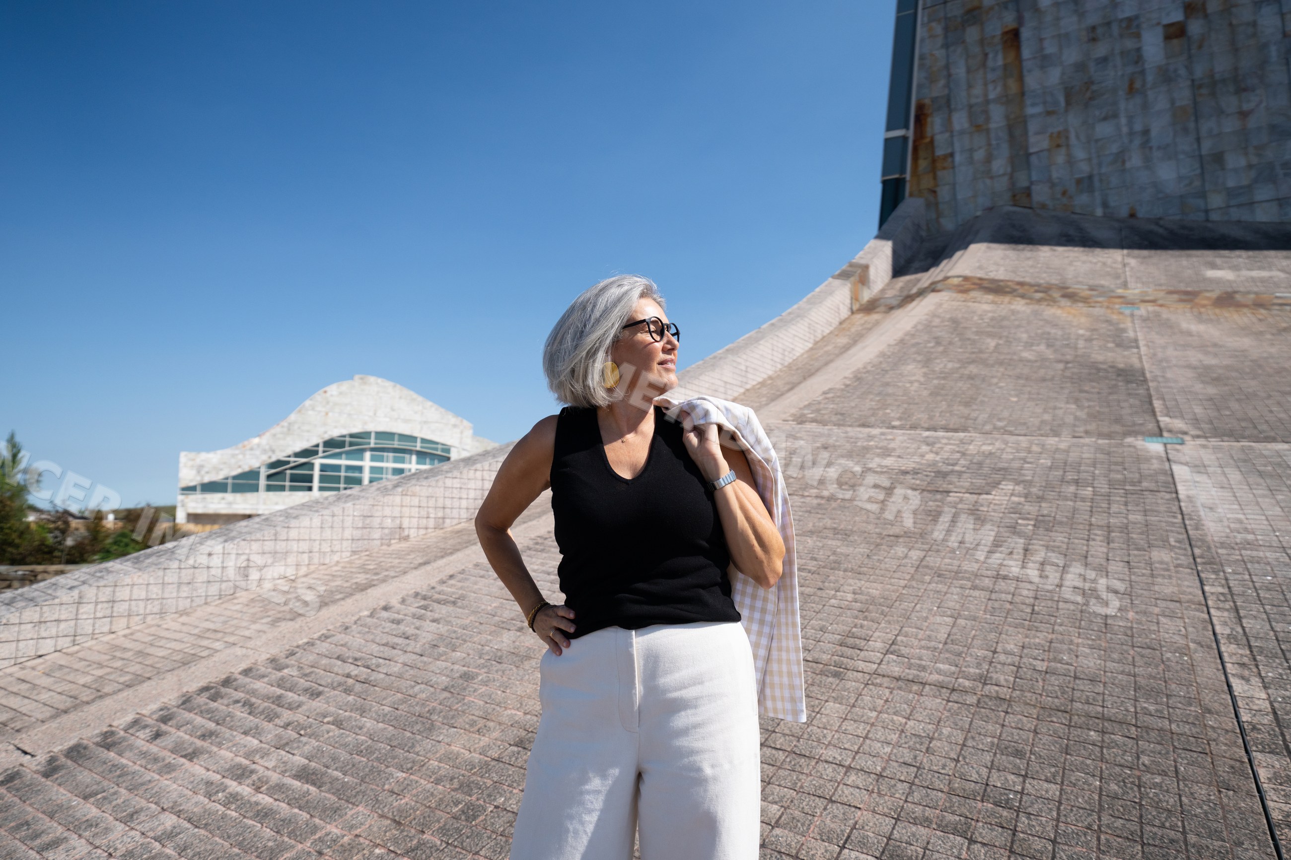 White woman standing in front of modern architecture