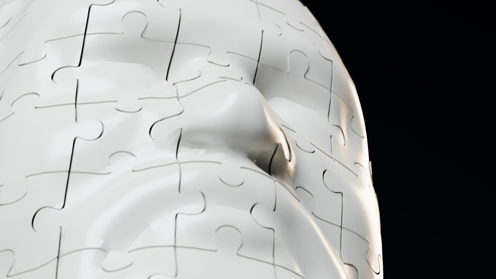 3d white human face puzzle sculpture on black background