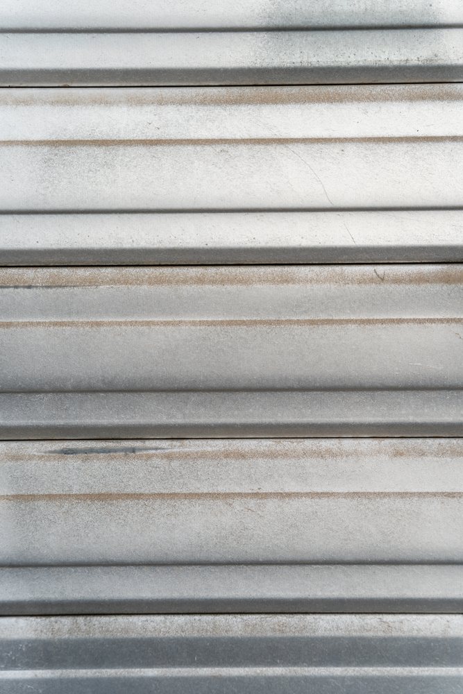 Corrugated metal surface with weathered horizontal stripes and texture
