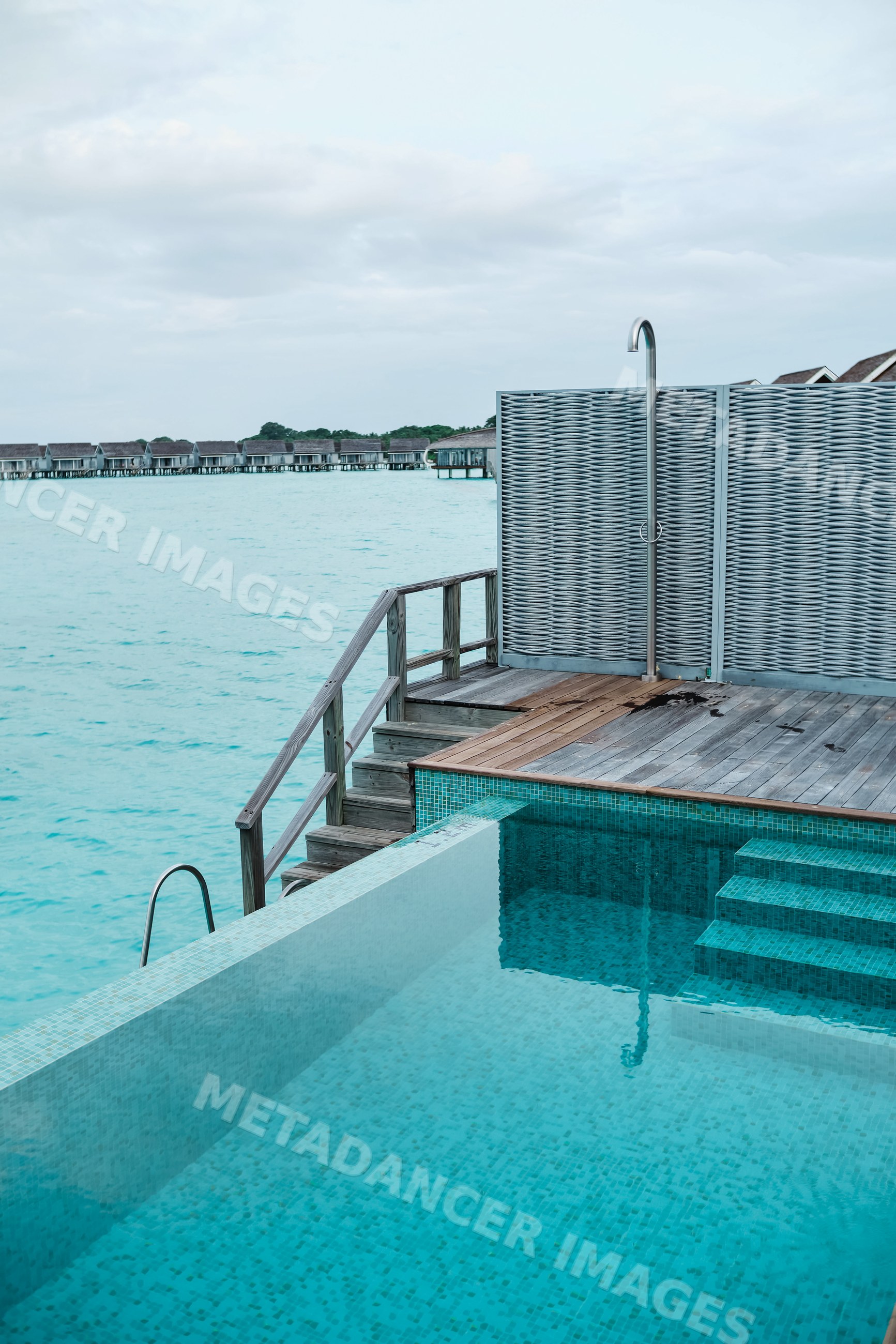 An infinity pool with outdoor shower at a tropical resort