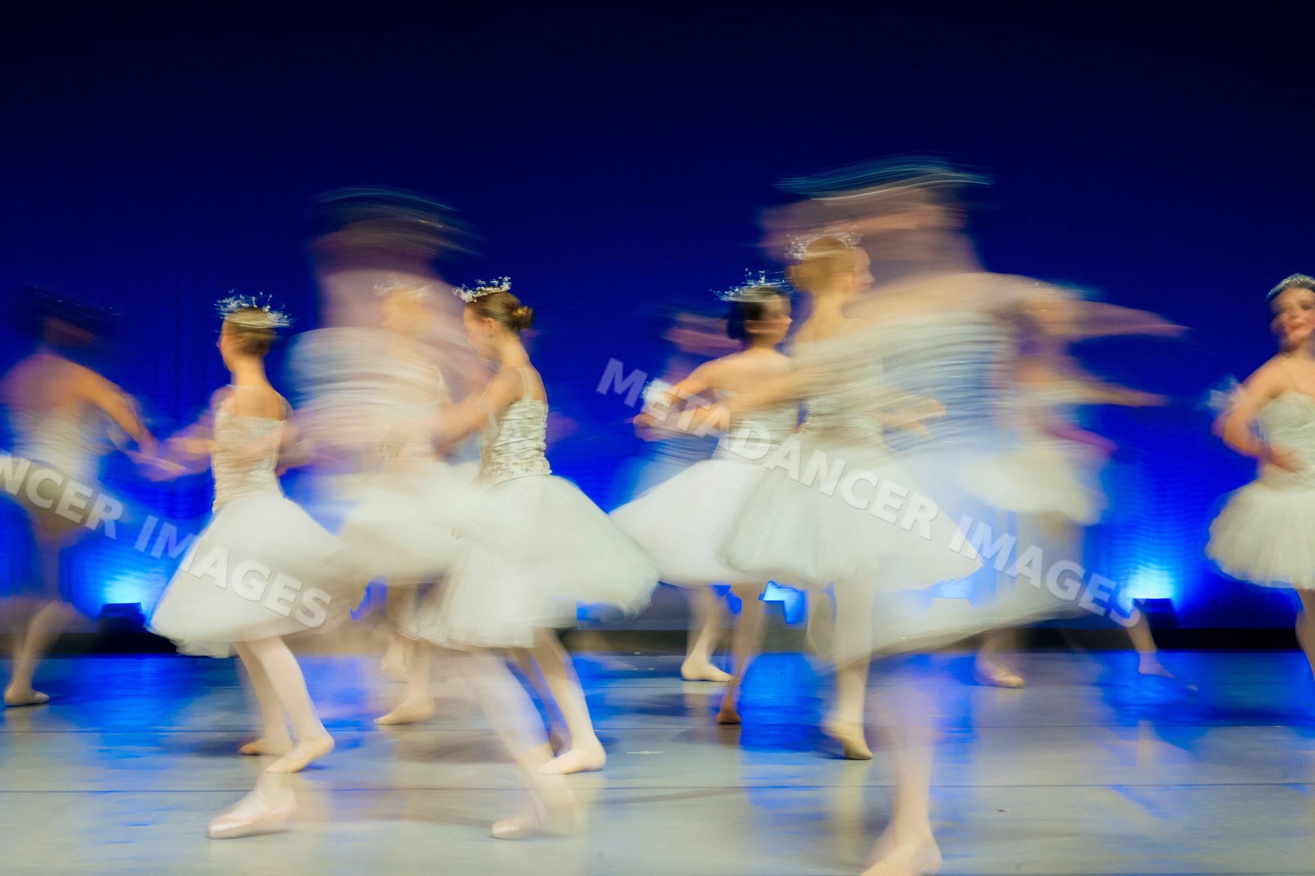 Young ballerinas perform a spinning ballet dance on stage