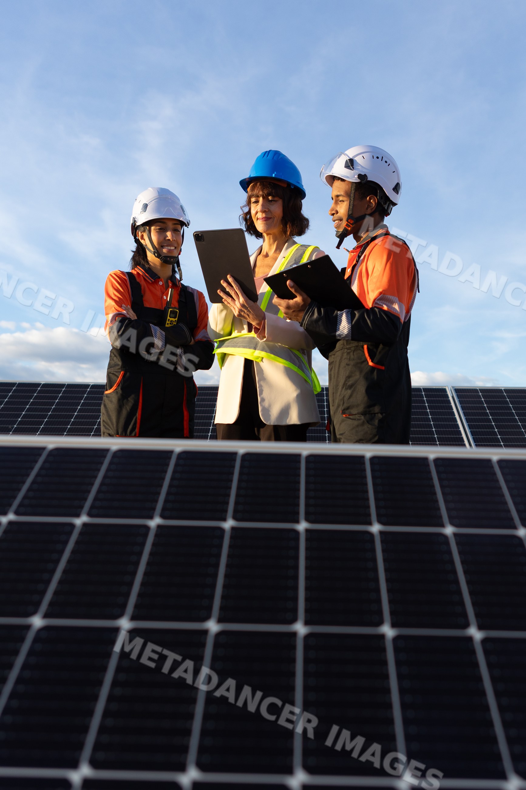 Hispanic and white workers discussing solar panels