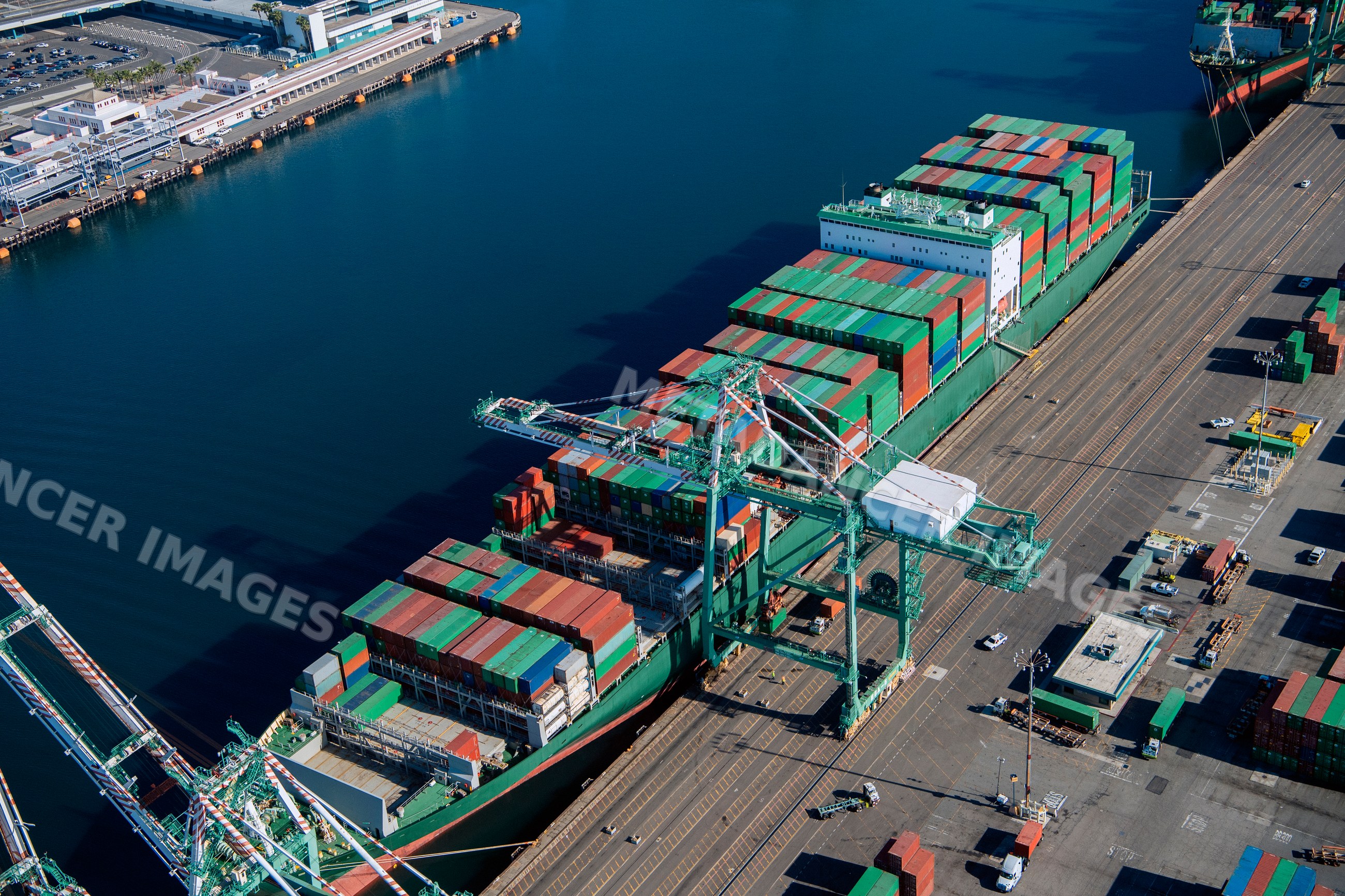 Container ship loading colorful shipping containers in a beach