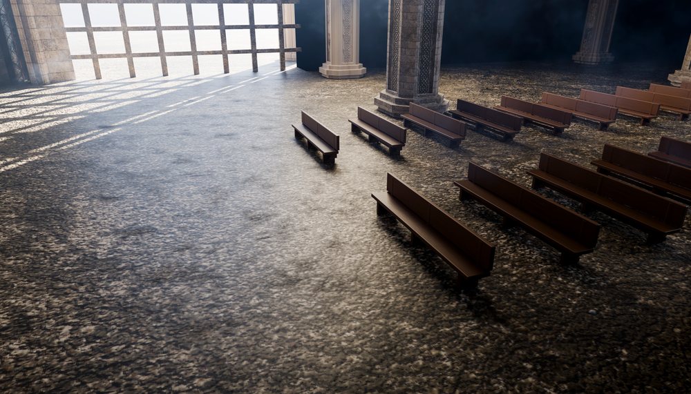 Empty church interior with wooden pews and stone pillars