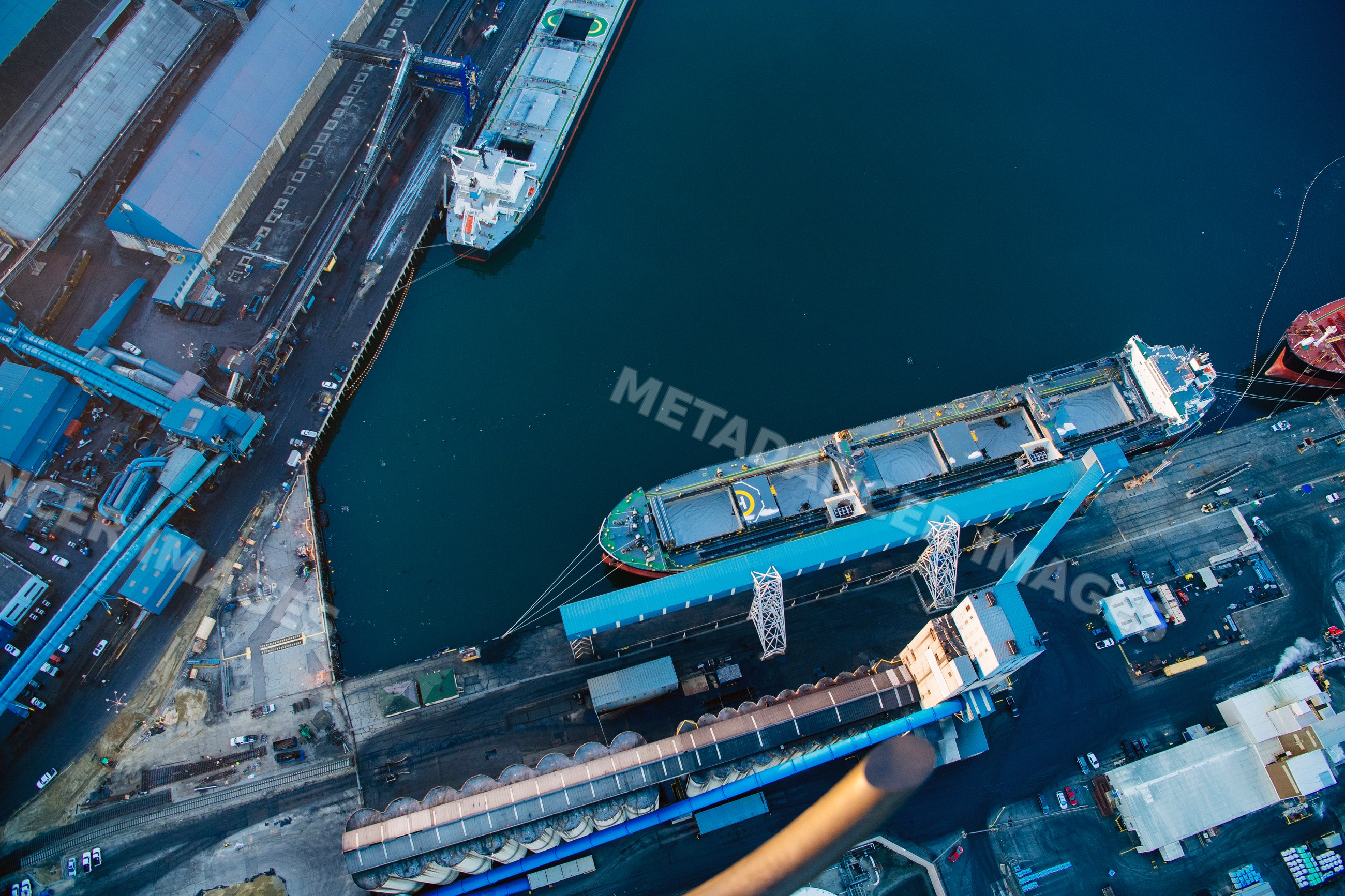 Cargo ship docked at industrial port loading dock in long beach
