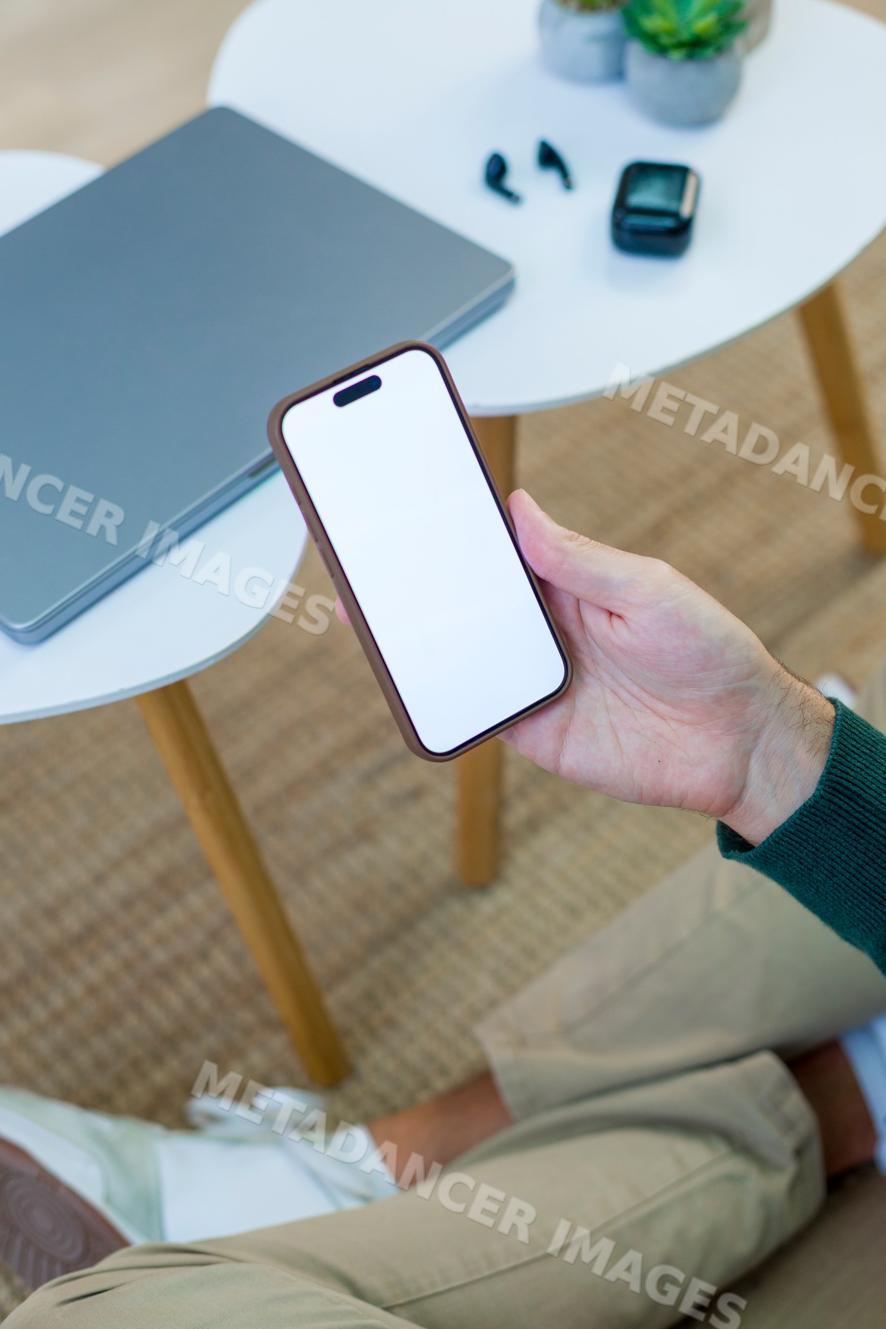 White person holding smartphone with blank screen