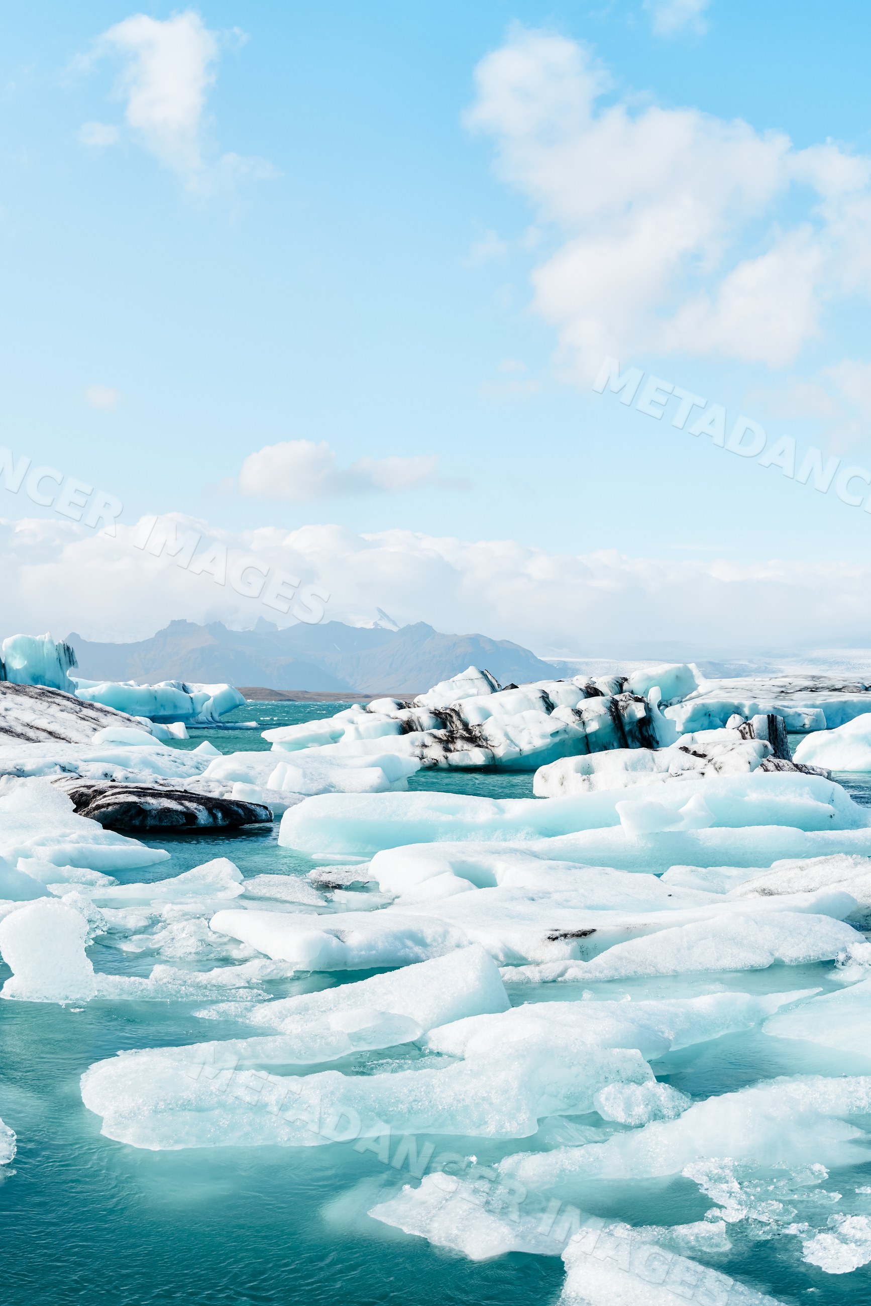Icebergs and glacier ice floating in a cold lagoon
