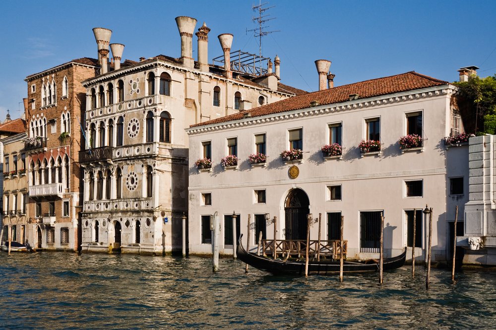 Gondola moored at historic buildings on venice's grand canal italy