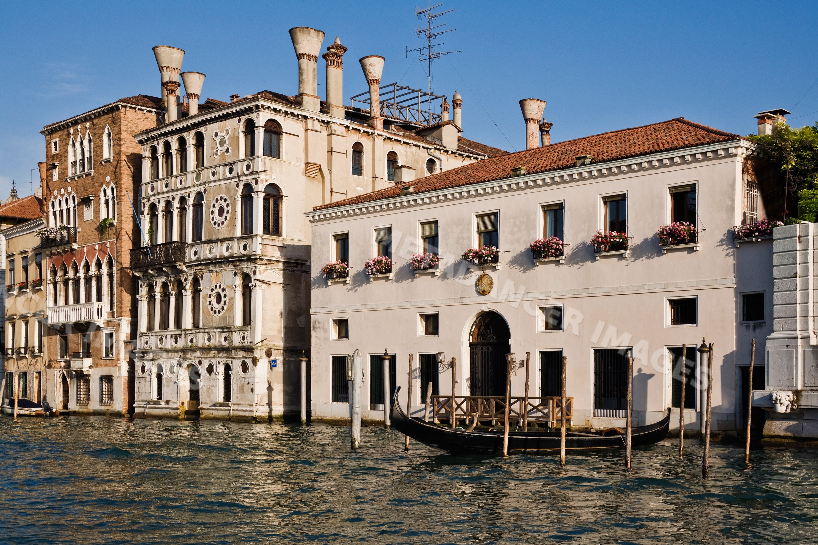 Gondola moored at historic buildings on venice's grand canal italy